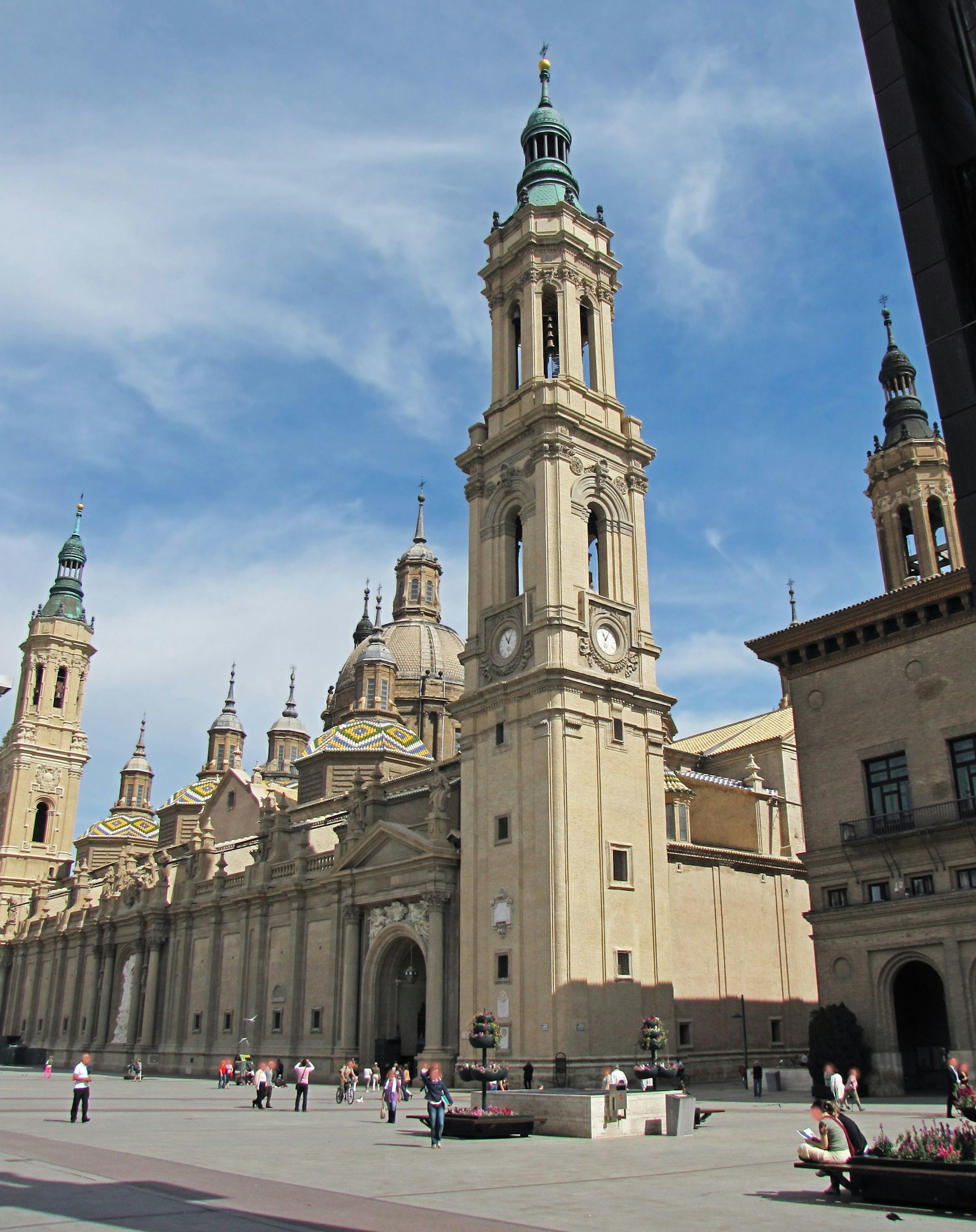 A stunning view of a plaza featuring tall architectural structures under a blue sky