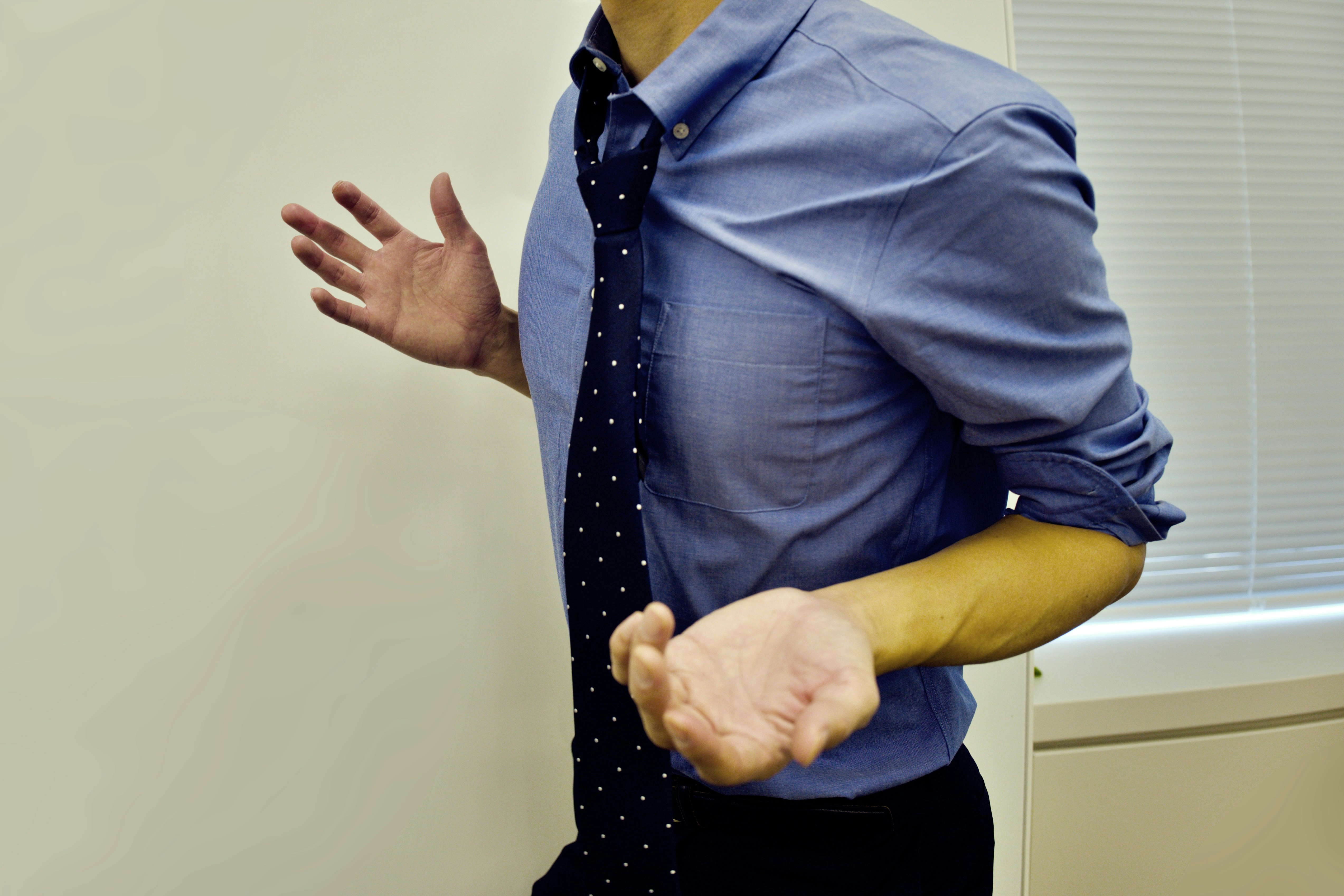upper body of a businessman adjusting his shirt and tie