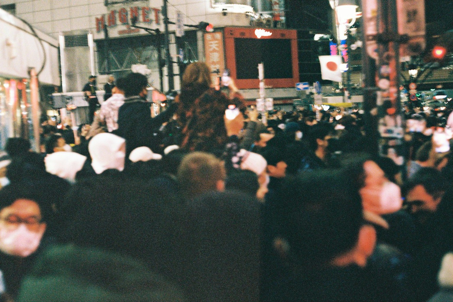 Crowd of people in a Tokyo street wearing masks