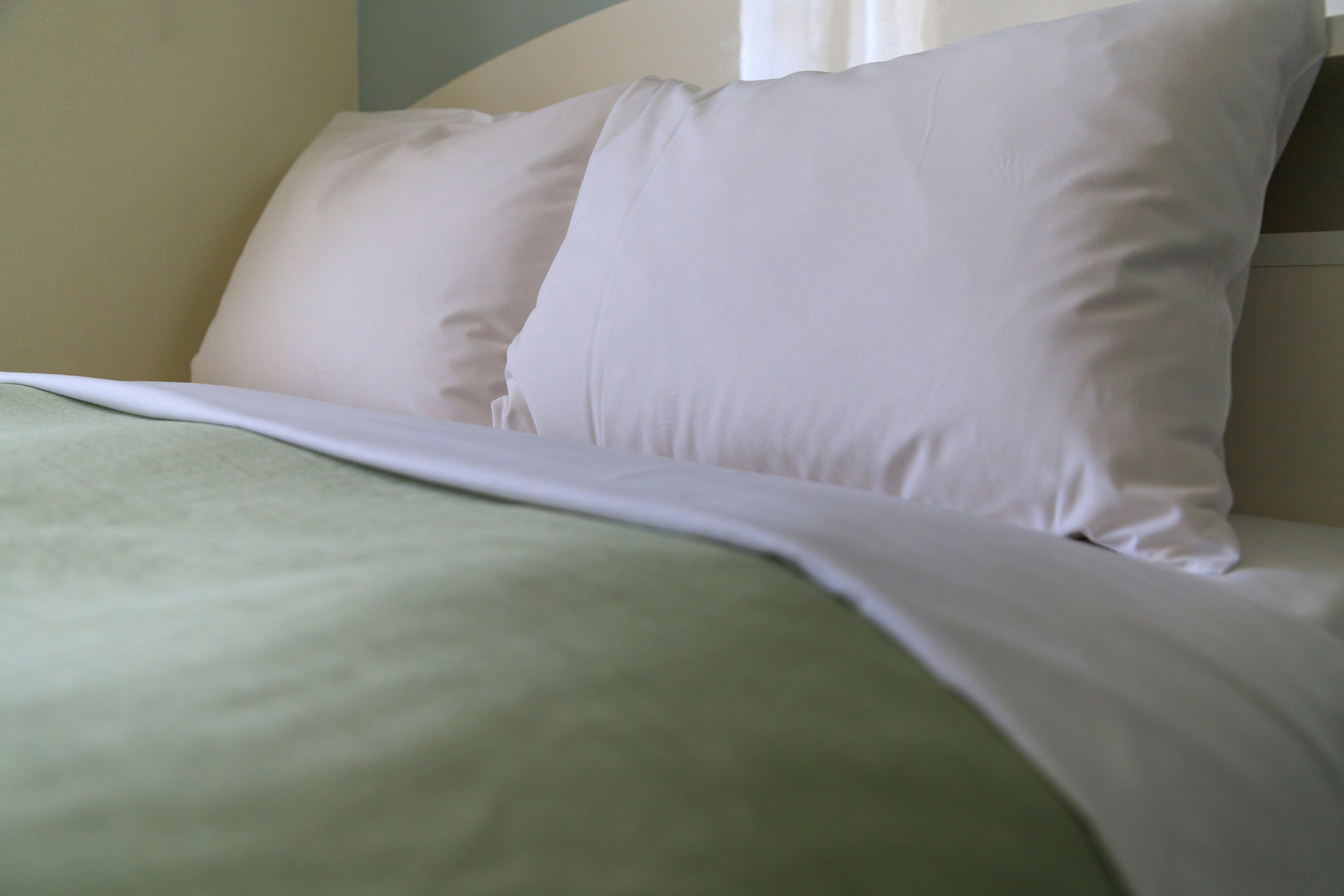 neatly made bed with pillows in a bedroom