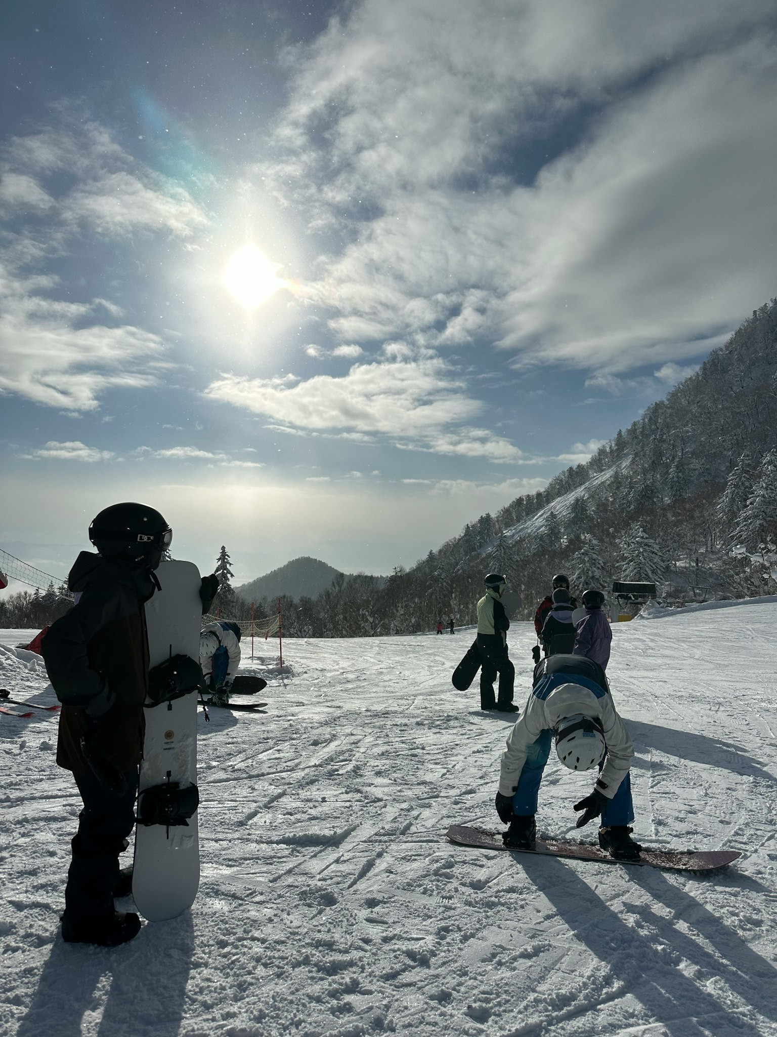 People enjoying snowboarding on a snowy mountain