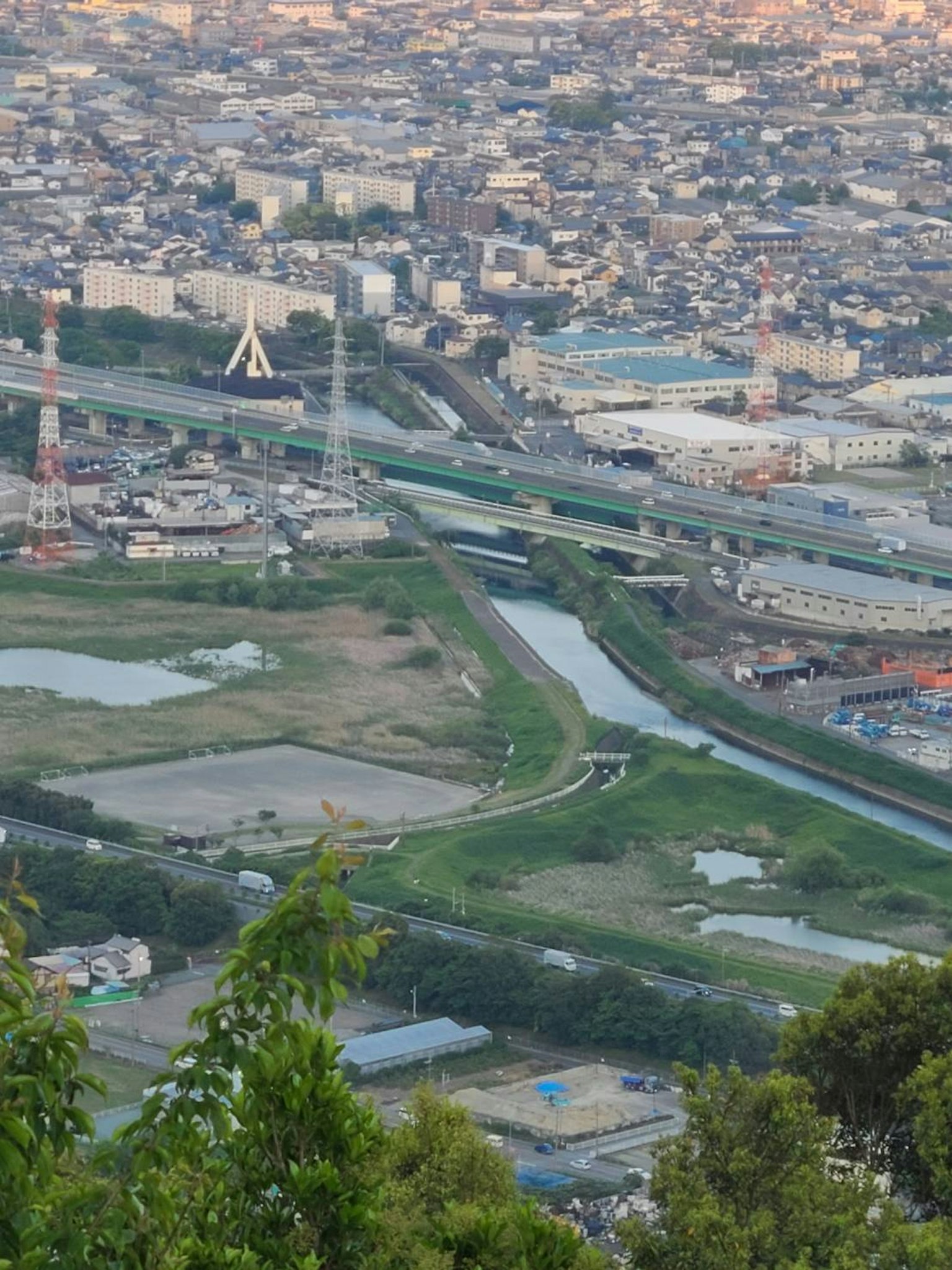 Vista aerea di un paesaggio urbano con colline verdi e un fiume