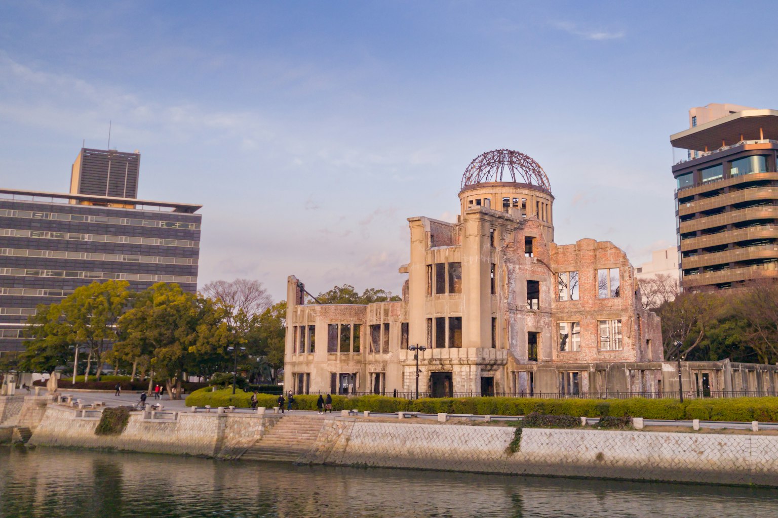 View of the Hiroshima Peace Memorial with modern buildings in the background