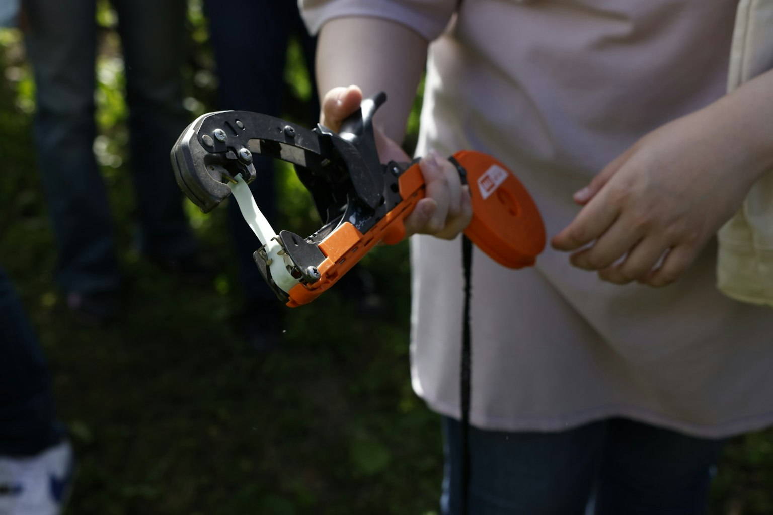 Image of a handheld orange tool with metallic parts