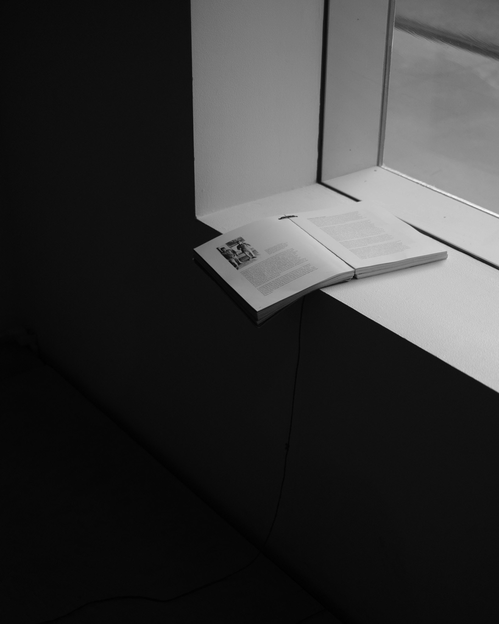 exhibition space with brochures and booklets on a white display table