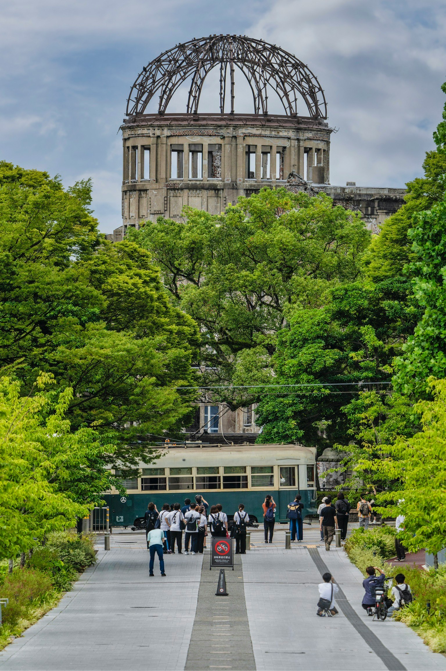Lush greenery of Hiroshima Peace Memorial Park with the distinctive dome of the Atomic Bomb Dome