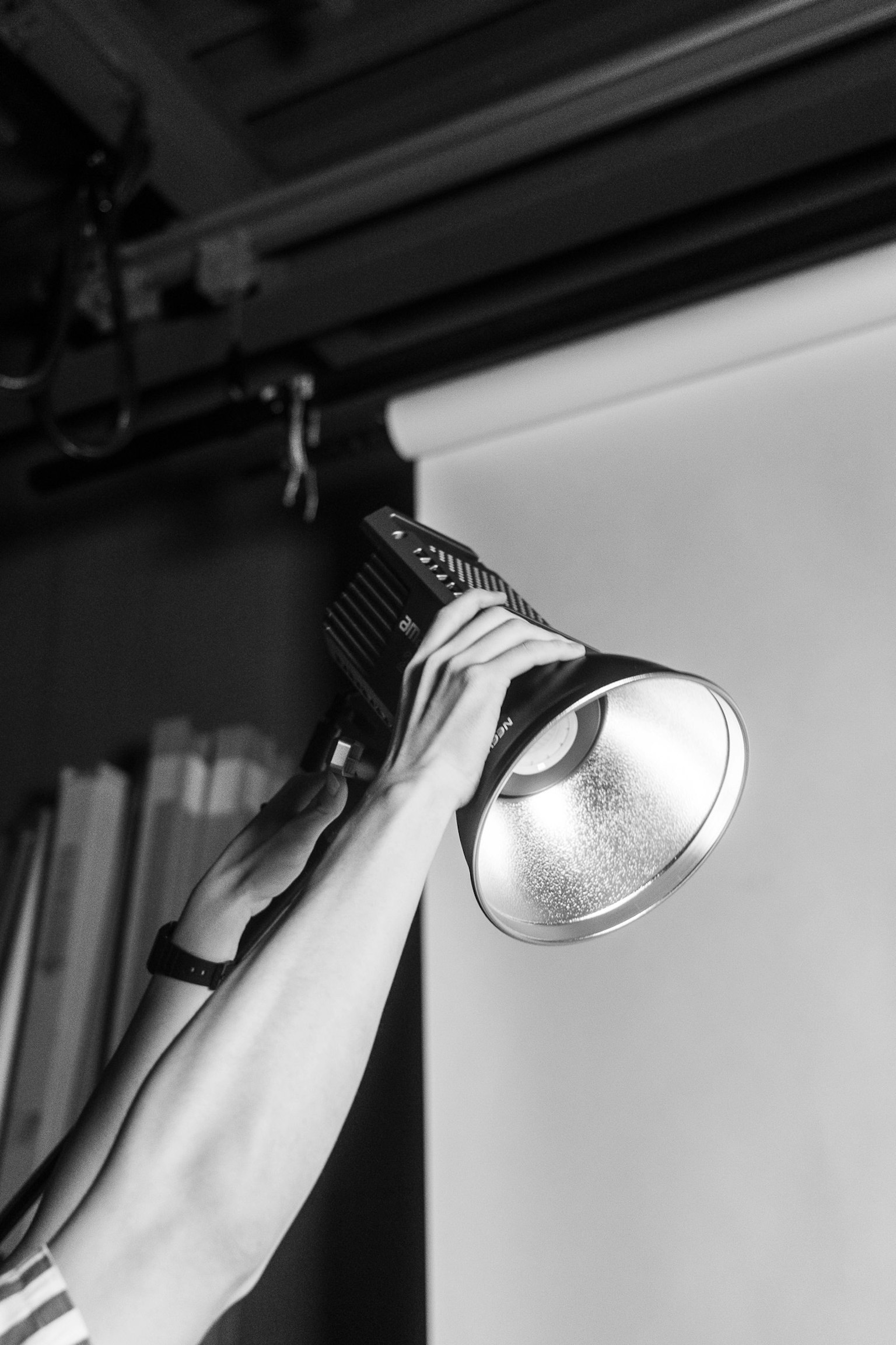 A person holding a flashlight up with one hand