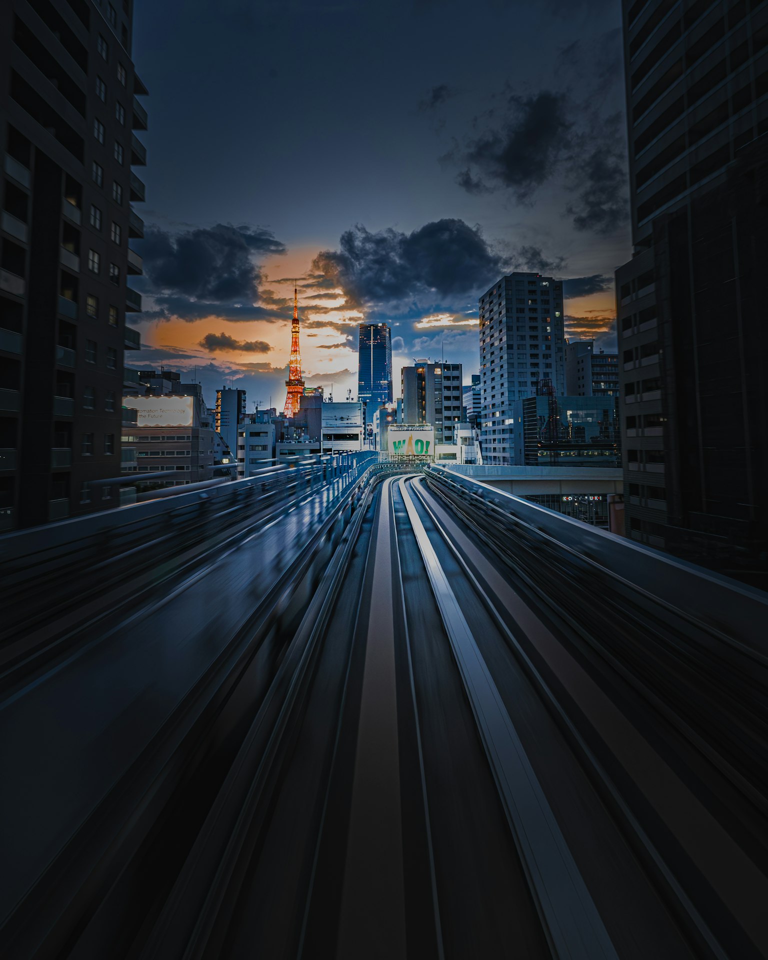 Stadtansicht von Tokio bei Dämmerung mit Gebäuden und Gleisen