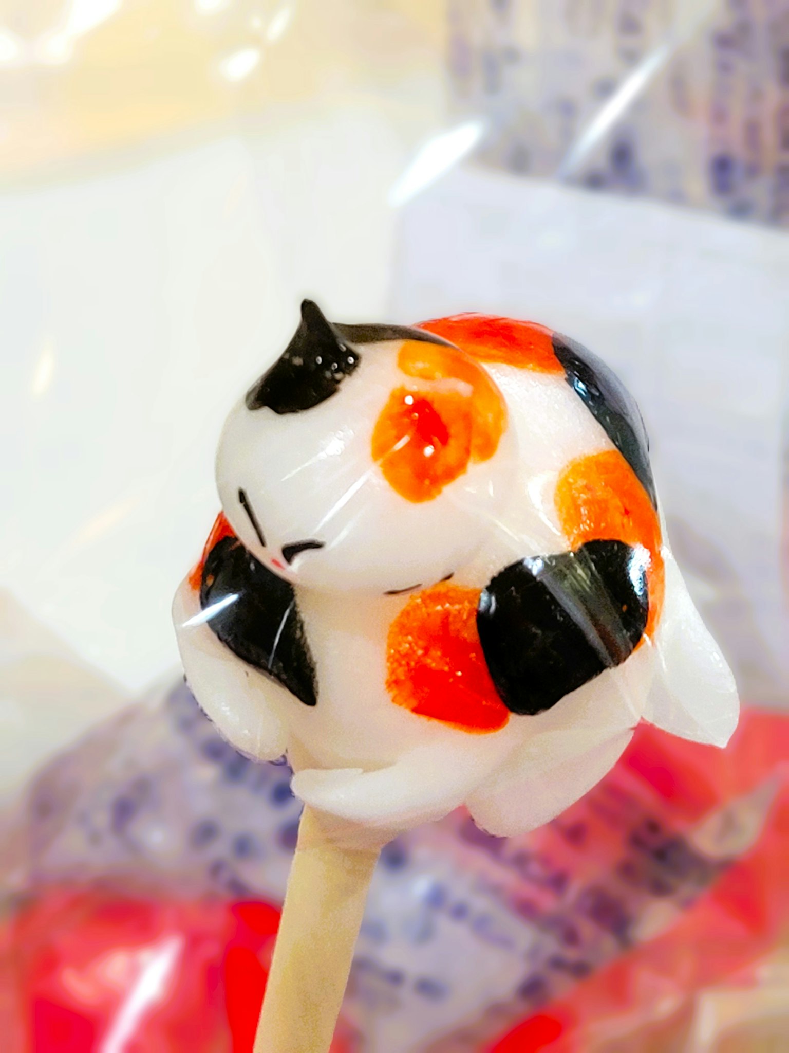 Colorful cat-shaped candy on a stick