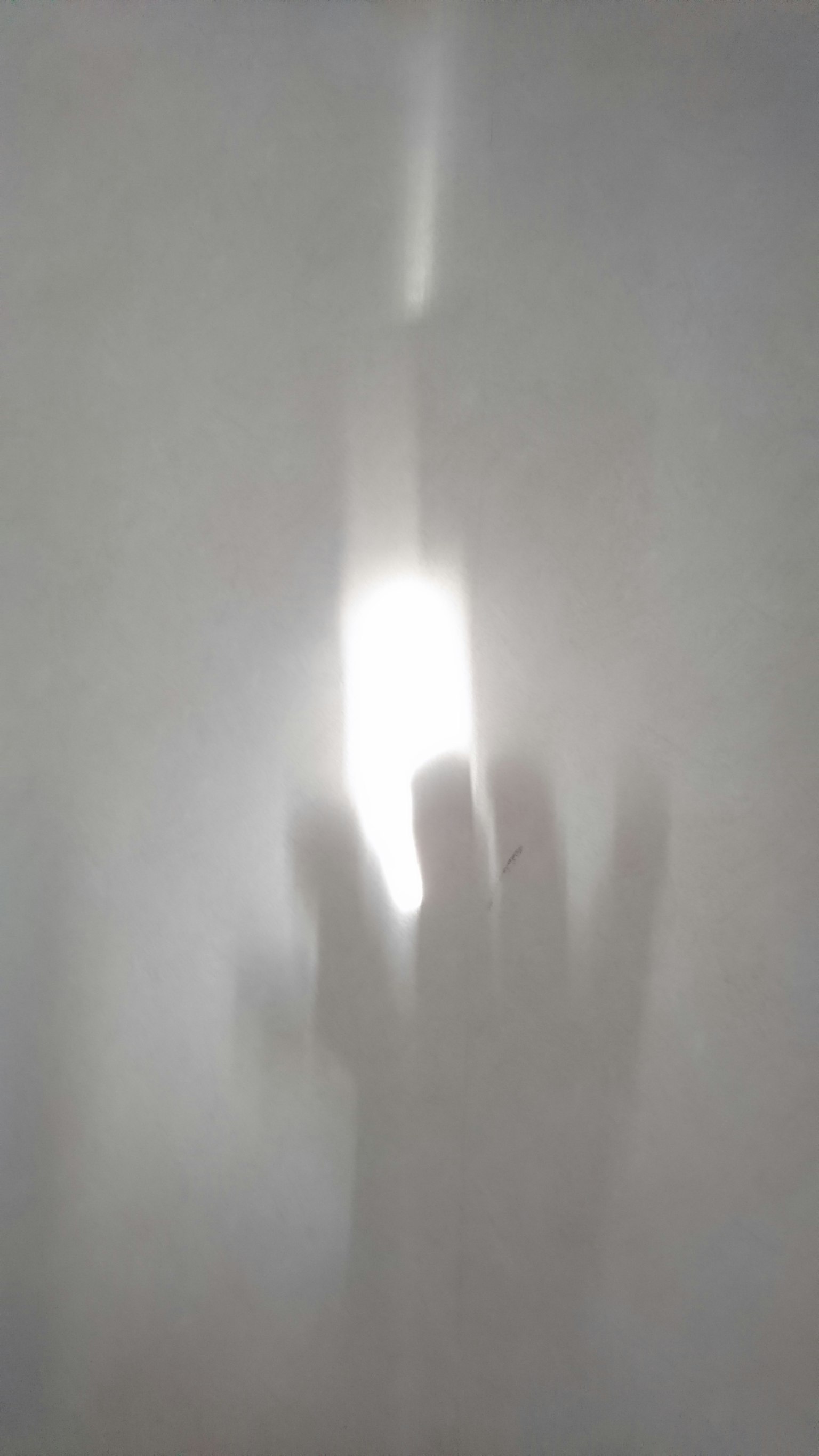 Silhouette of a hand reaching towards light