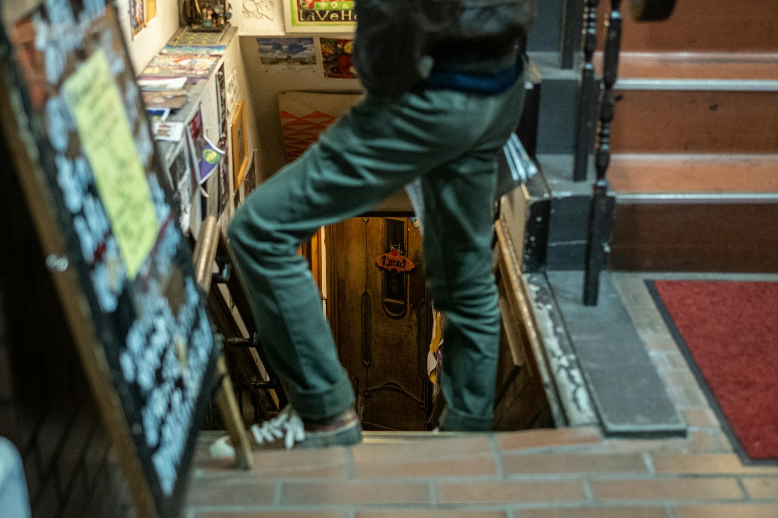 Person descending stairs with visible surroundings and atmosphere