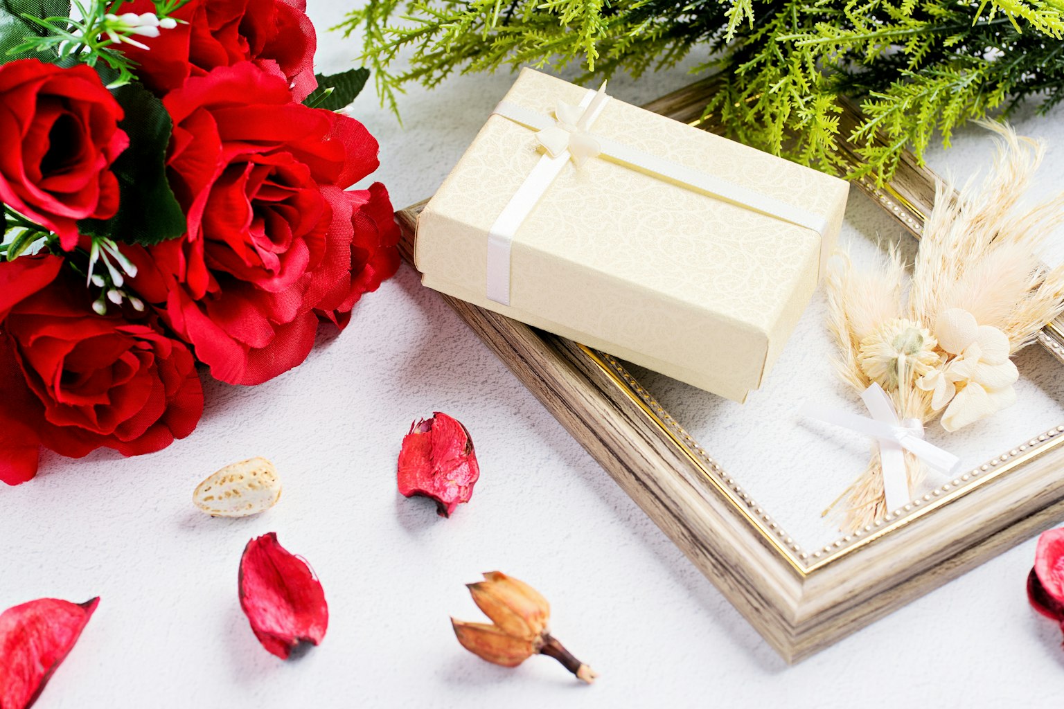 Arrangement of red roses and gift box
