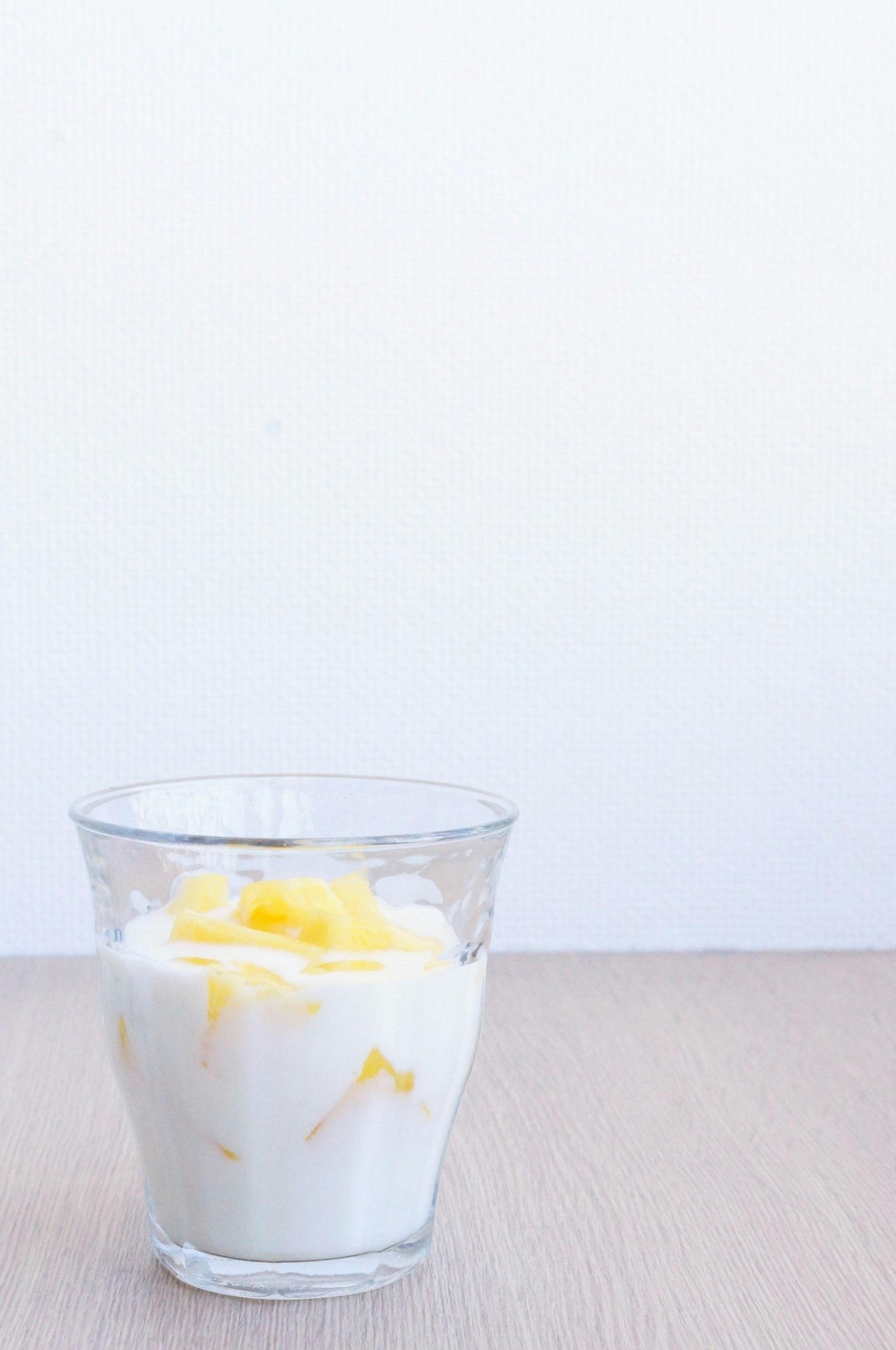 Yogurt topped with mango in a clear glass
