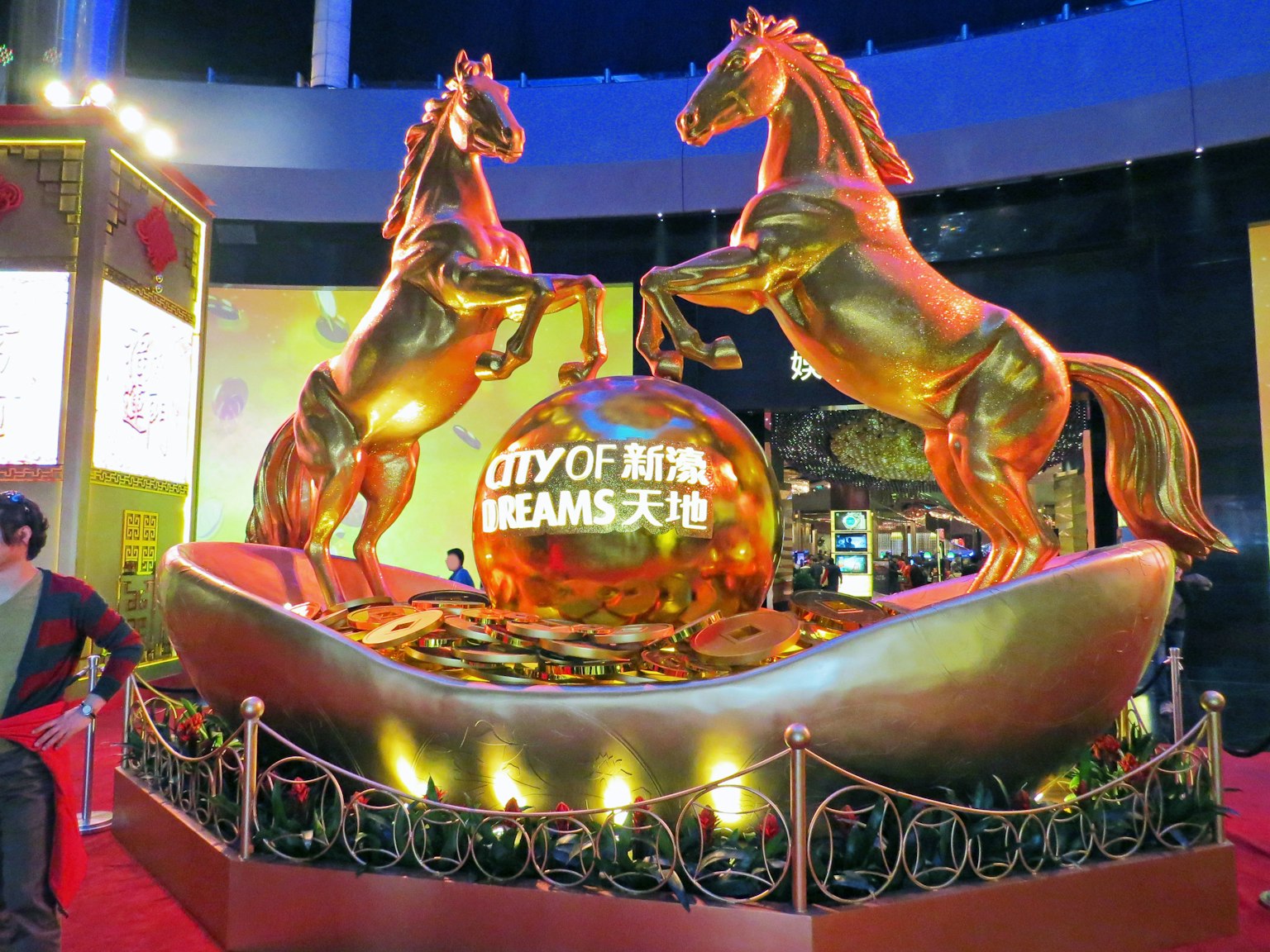 Golden horse sculpture with the words City of Dreams on a globe