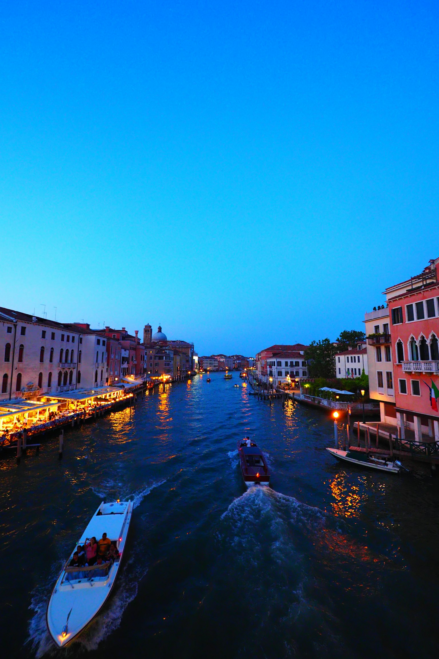 Khung cảnh đêm Venice với bầu trời xanh và các tòa nhà dọc theo kênh