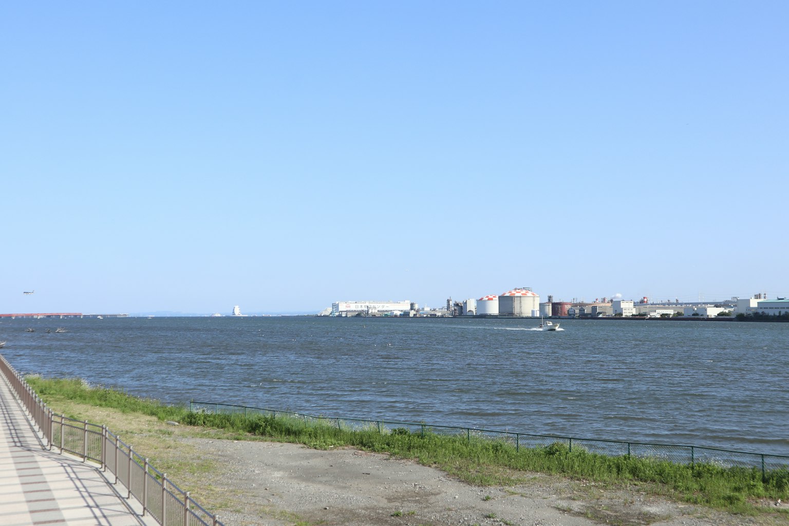 Scenic view of a river with a clear blue sky and green grass along the bank