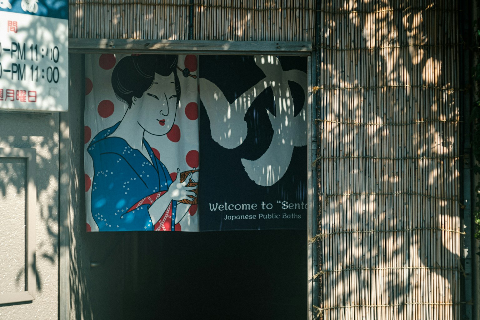 Storefront featuring an illustration of a woman in a blue kimono with red polka dots and a sign reading Welcome to Tofu