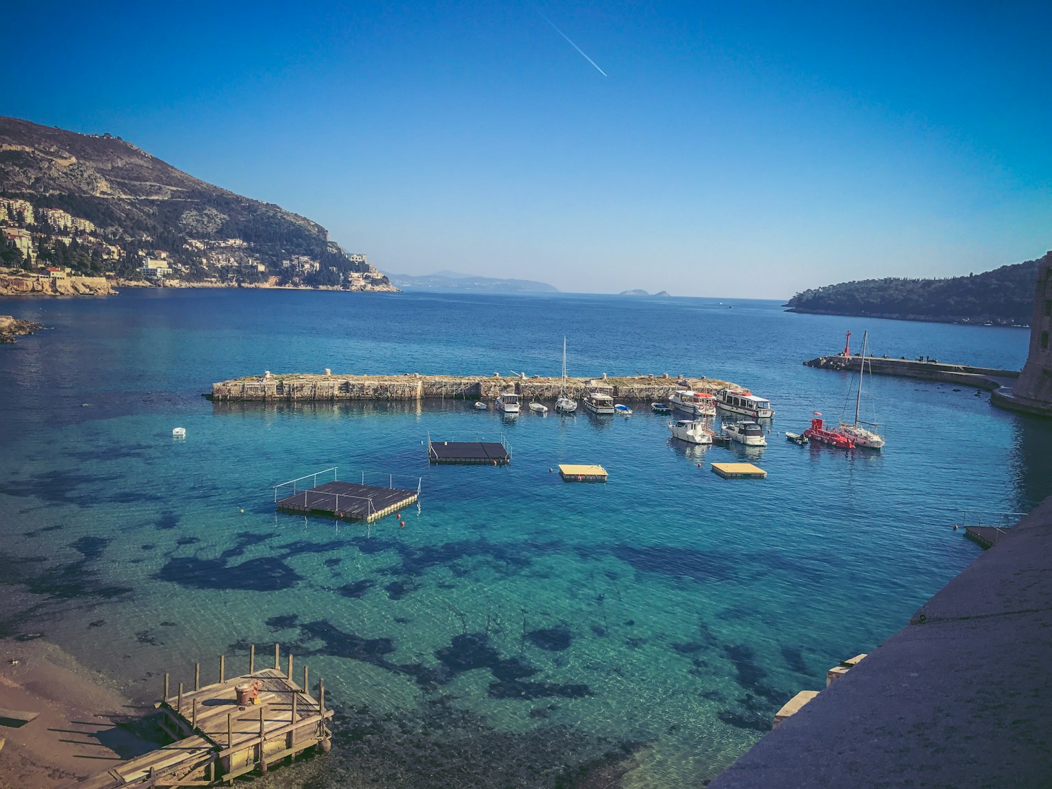Scenic harbor view with clear blue water and small boats