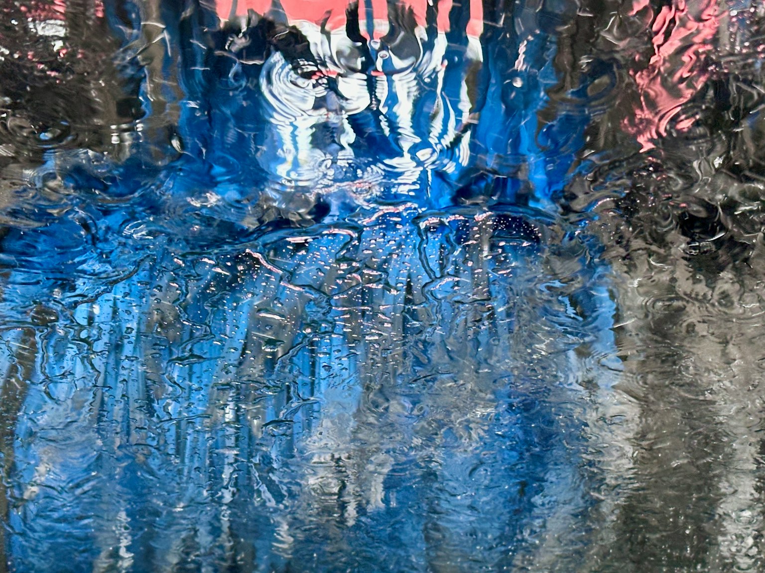 Abstract image of a water surface reflecting blue and black hues