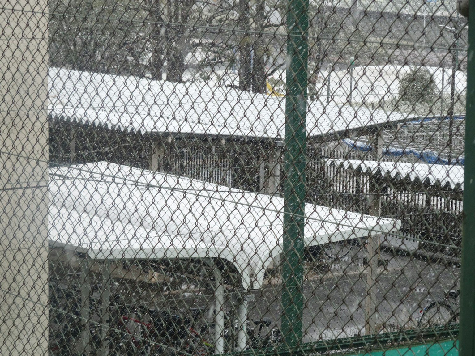 被雪覆蓋的屋頂和冬季場景中的圍籬