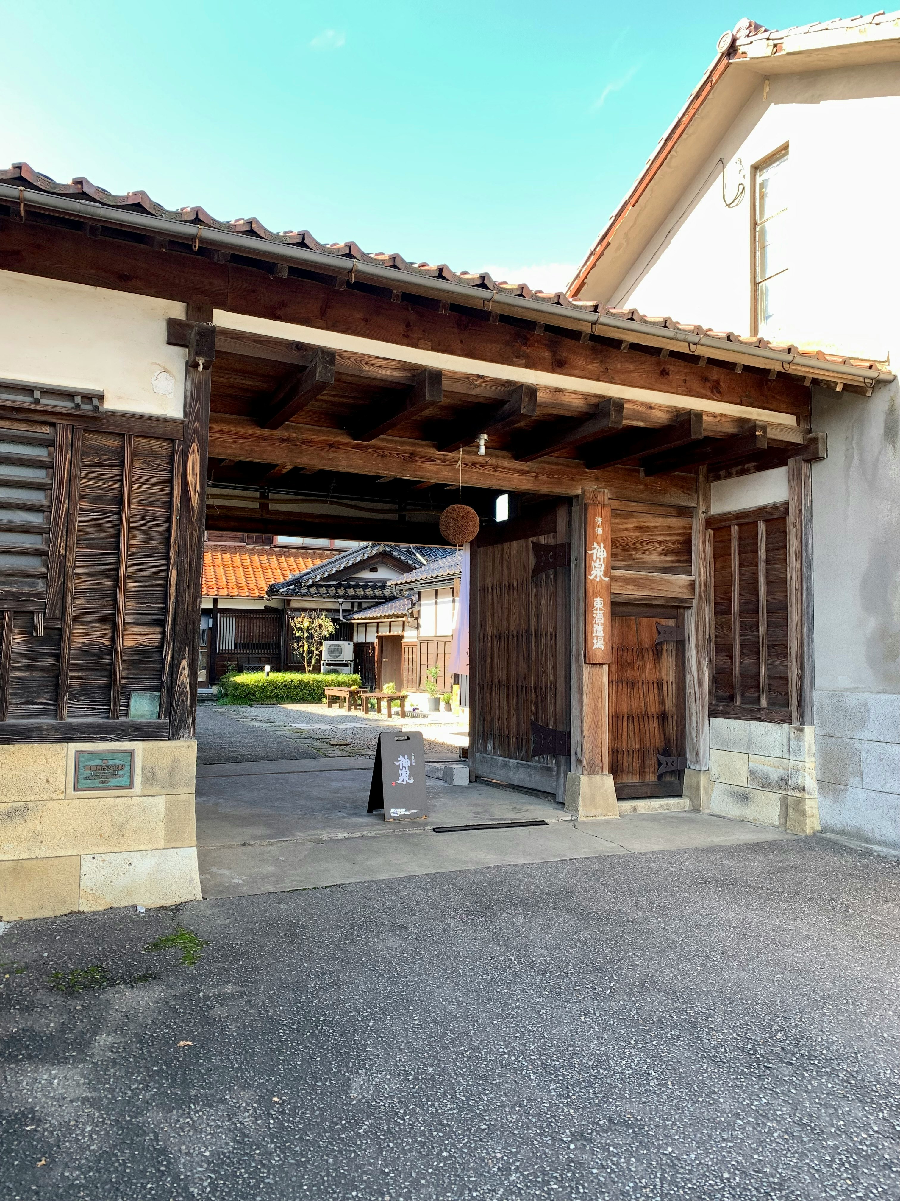 entrance of an old wooden townhouse with a gate and eaves