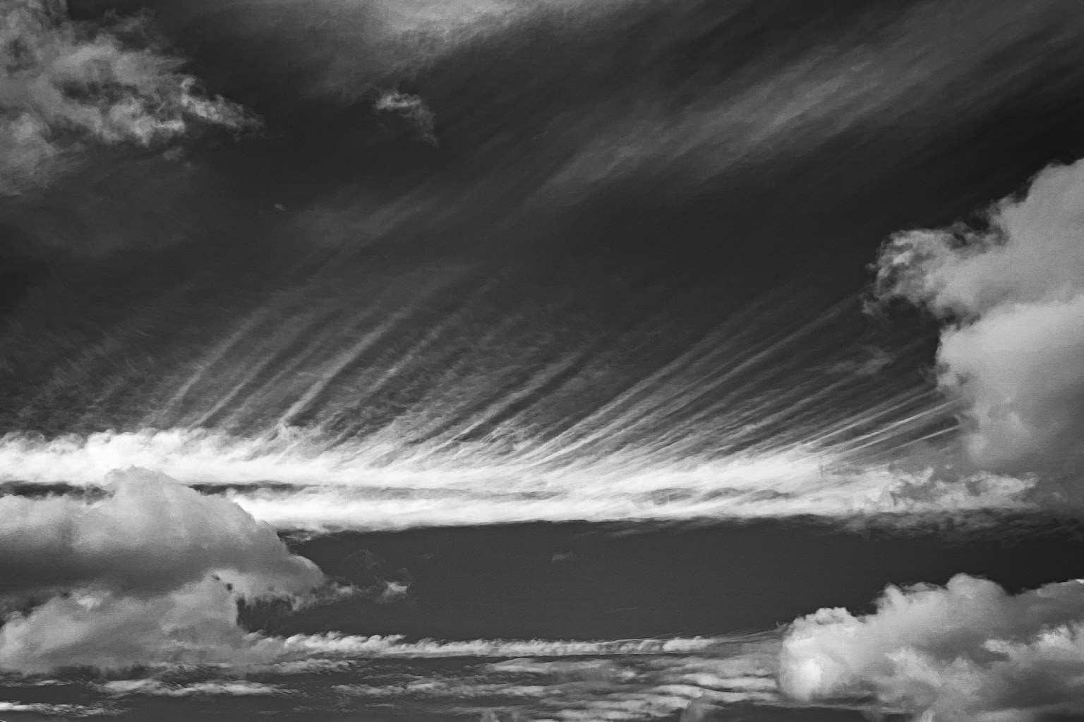 Black and white sky with streaks of clouds