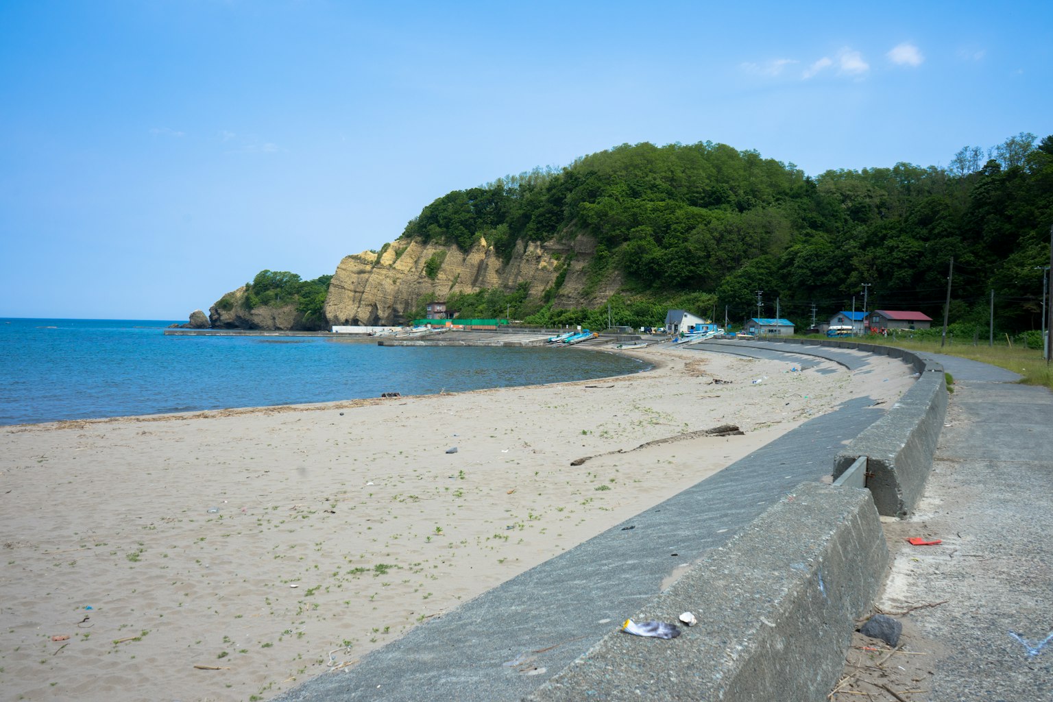 Scenic beach view with coastline and green hills