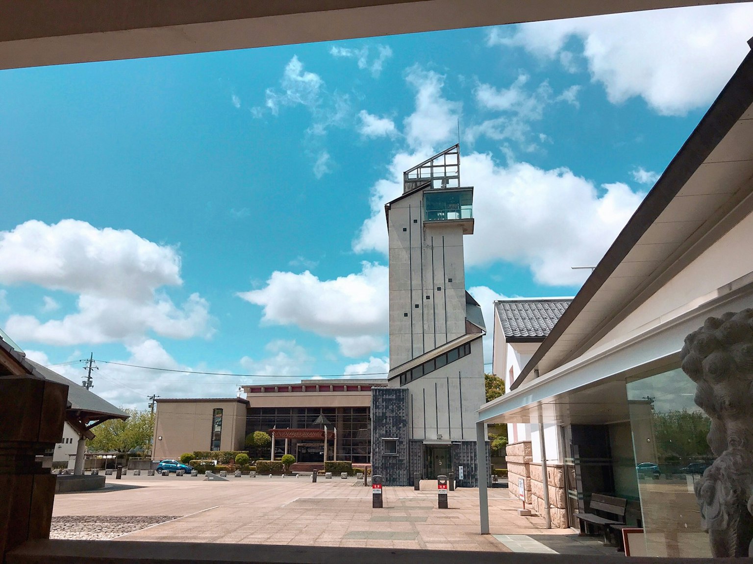 Modernes Gebäude und traditionelle Architektur unter einem blauen Himmel mit weißen Wolken