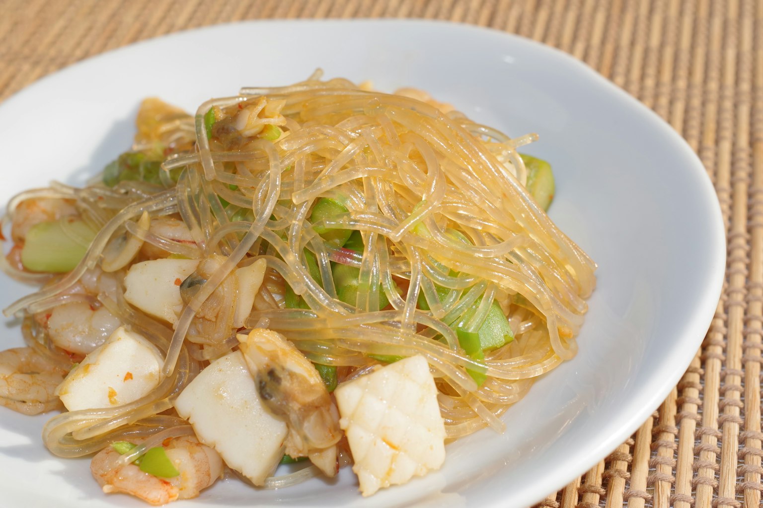 Plate of stir-fried glass noodles with shrimp and vegetables