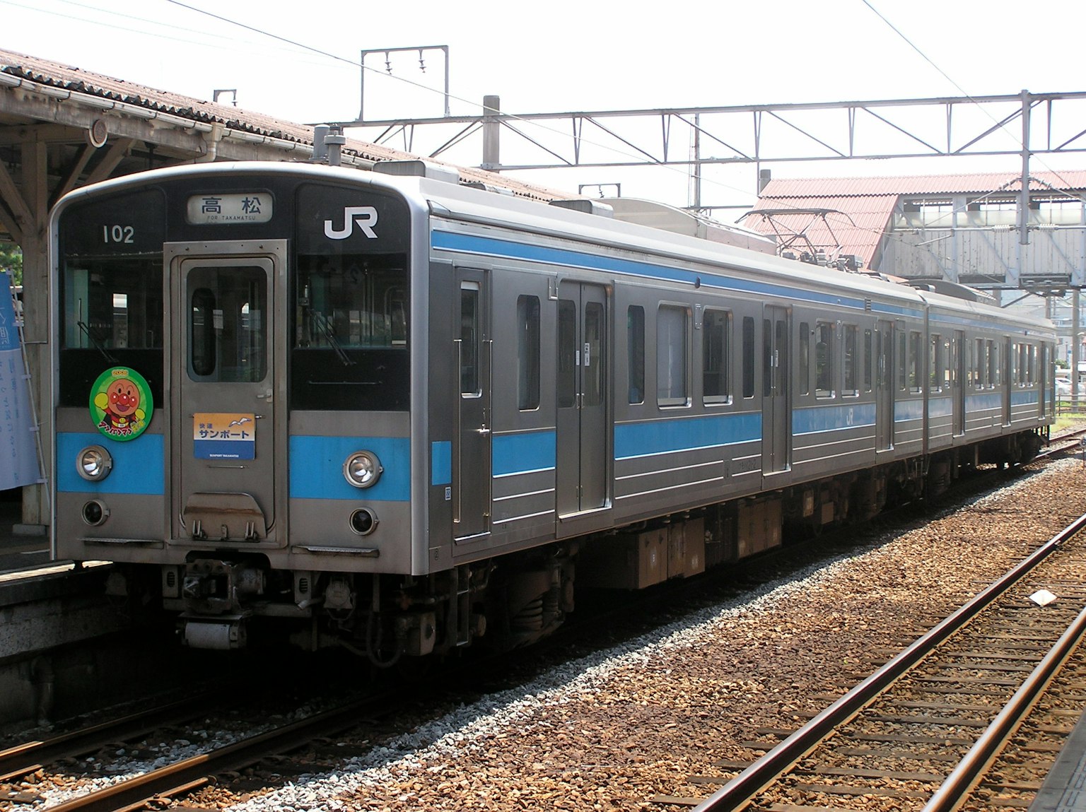 Blue and silver JR train parked at the station