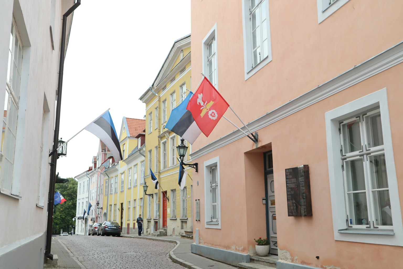 Charming street in Tallinn with colorful buildings and flags