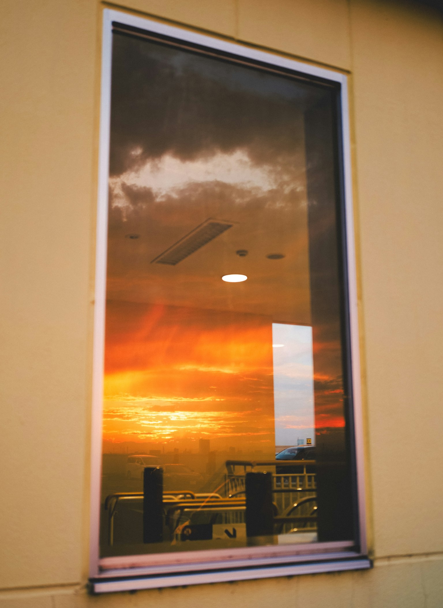Reflection of a sunset sky and clouds in a window