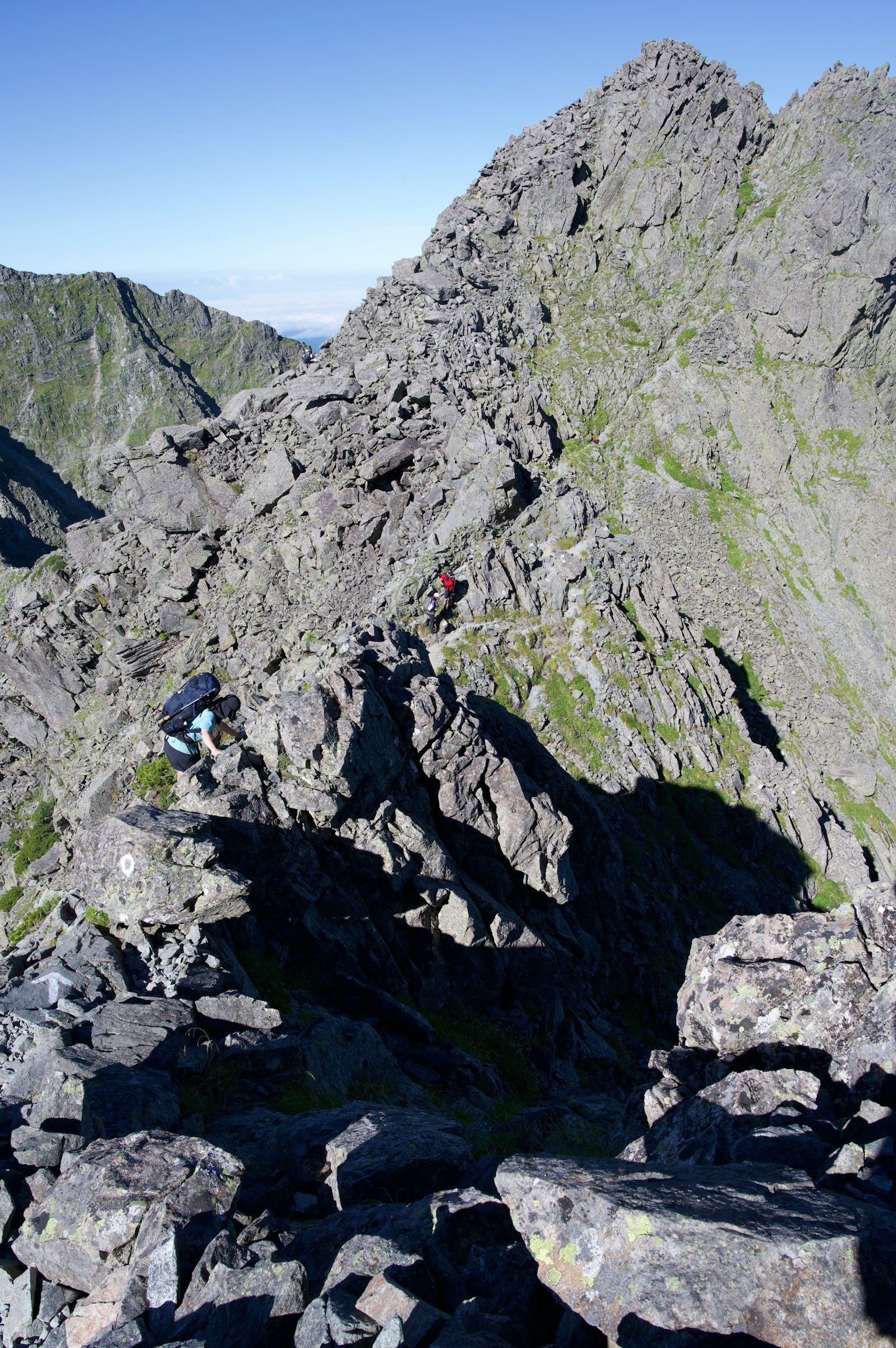 Climbers navigating rocky terrain on a mountain