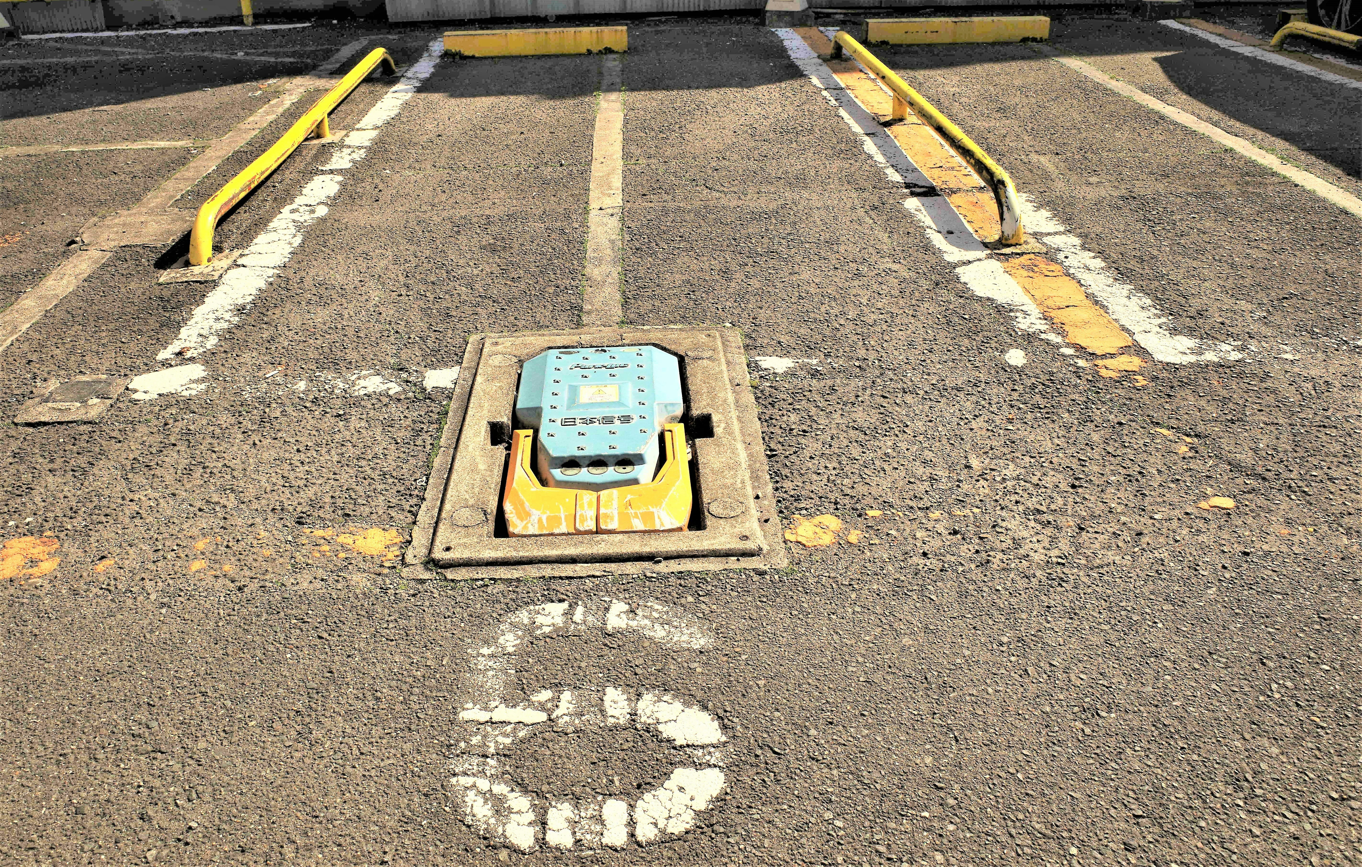 Road markings and parking stop for coin parking spot 6