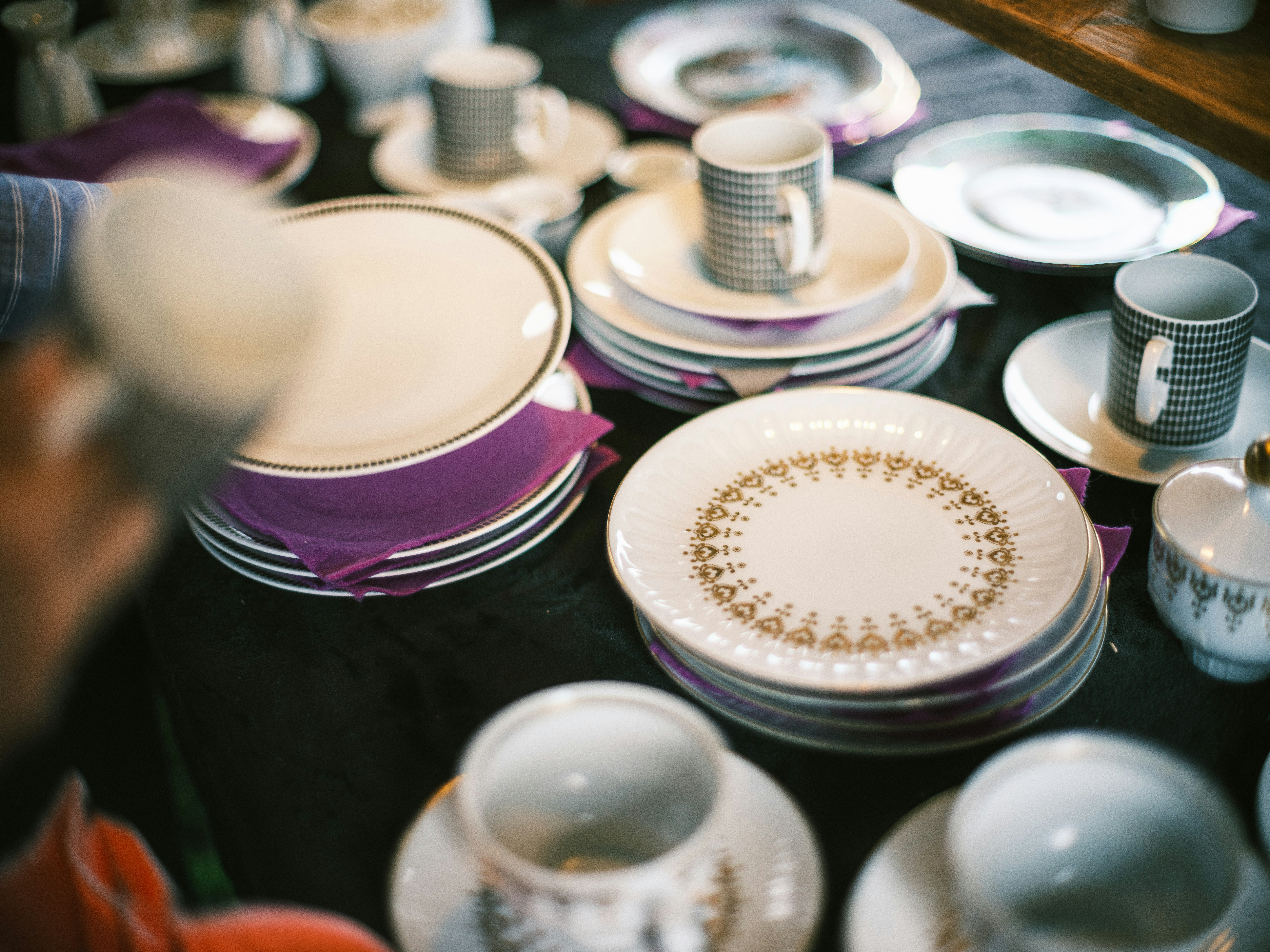 table at a flea market with purple-and-white dinnerware