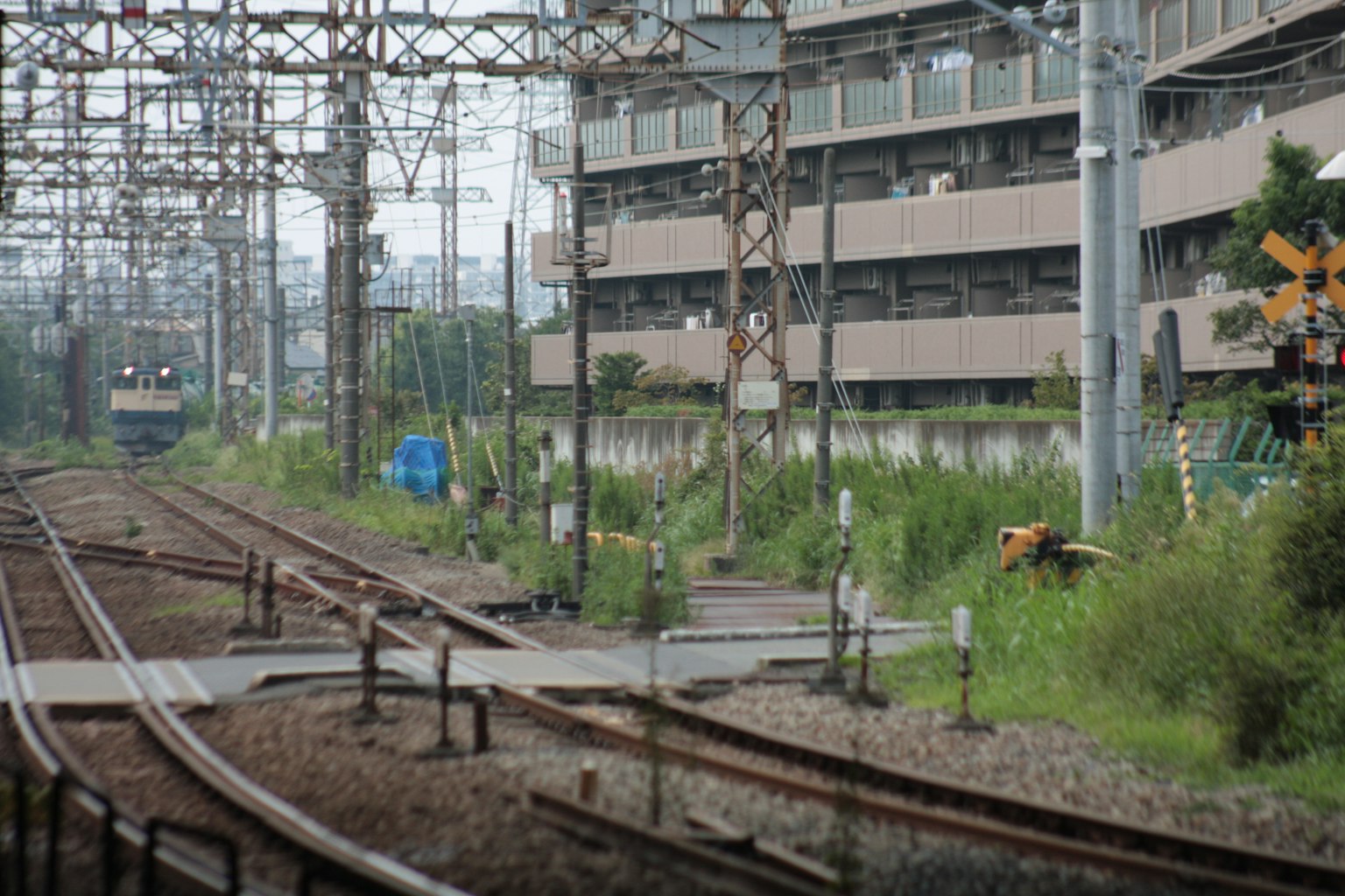 Urban landscape featuring railway tracks and surrounding greenery