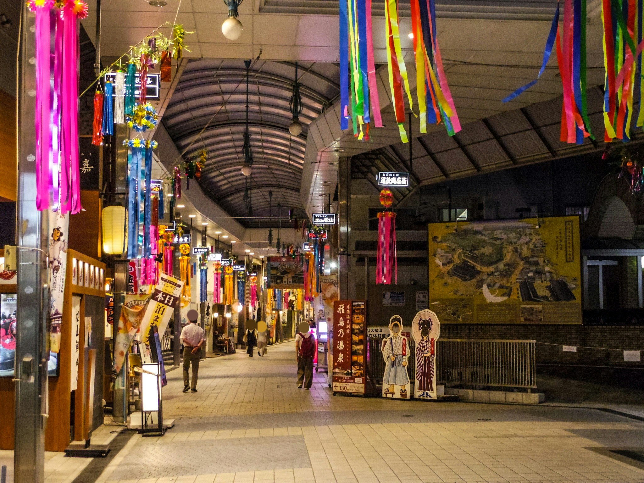 covered shopping arcade street lined with colorful hanging decorations