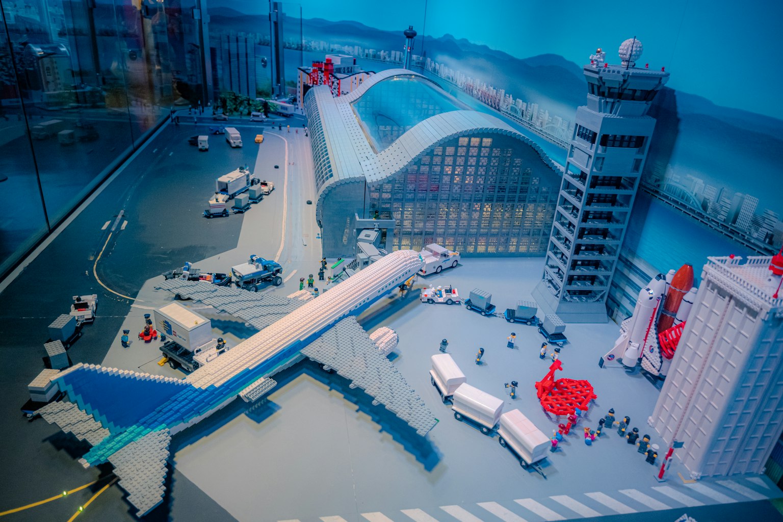 LEGO model of an airport with an airplane and service vehicles