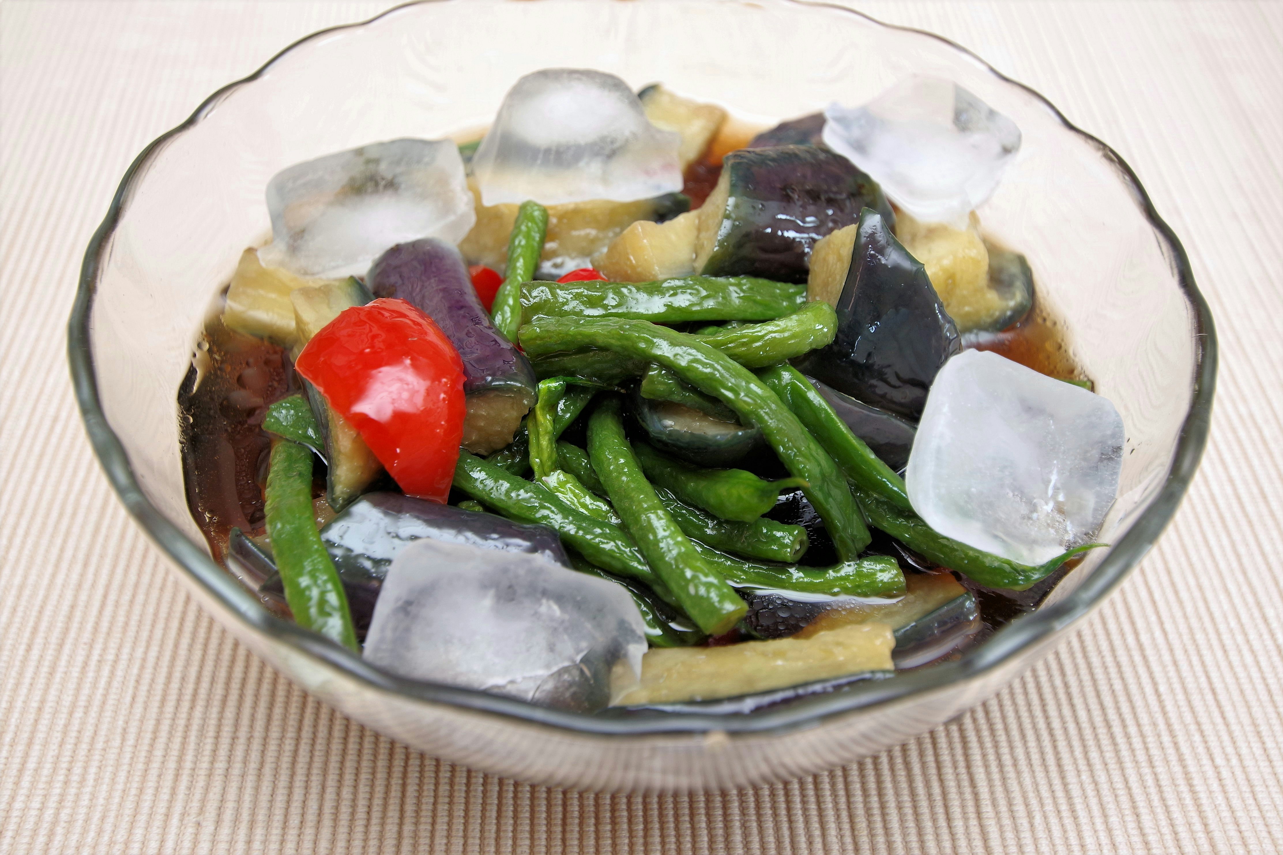 bowl of chilled soup with ice and vegetables
