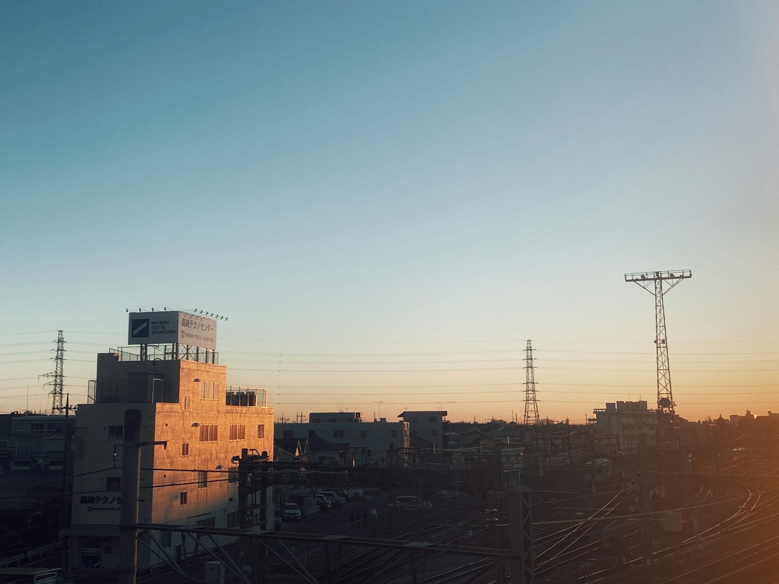 Cityscape featuring a sunset sky and building silhouettes