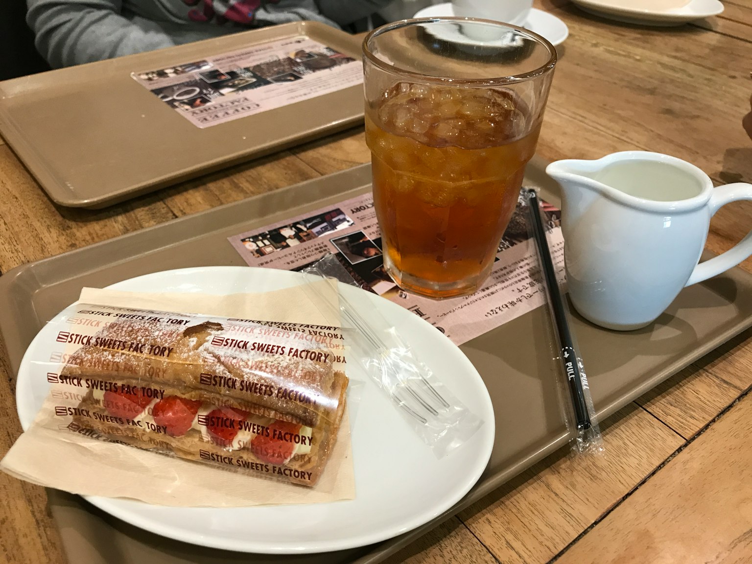 Strawberry pastry with iced tea on a cafe tray