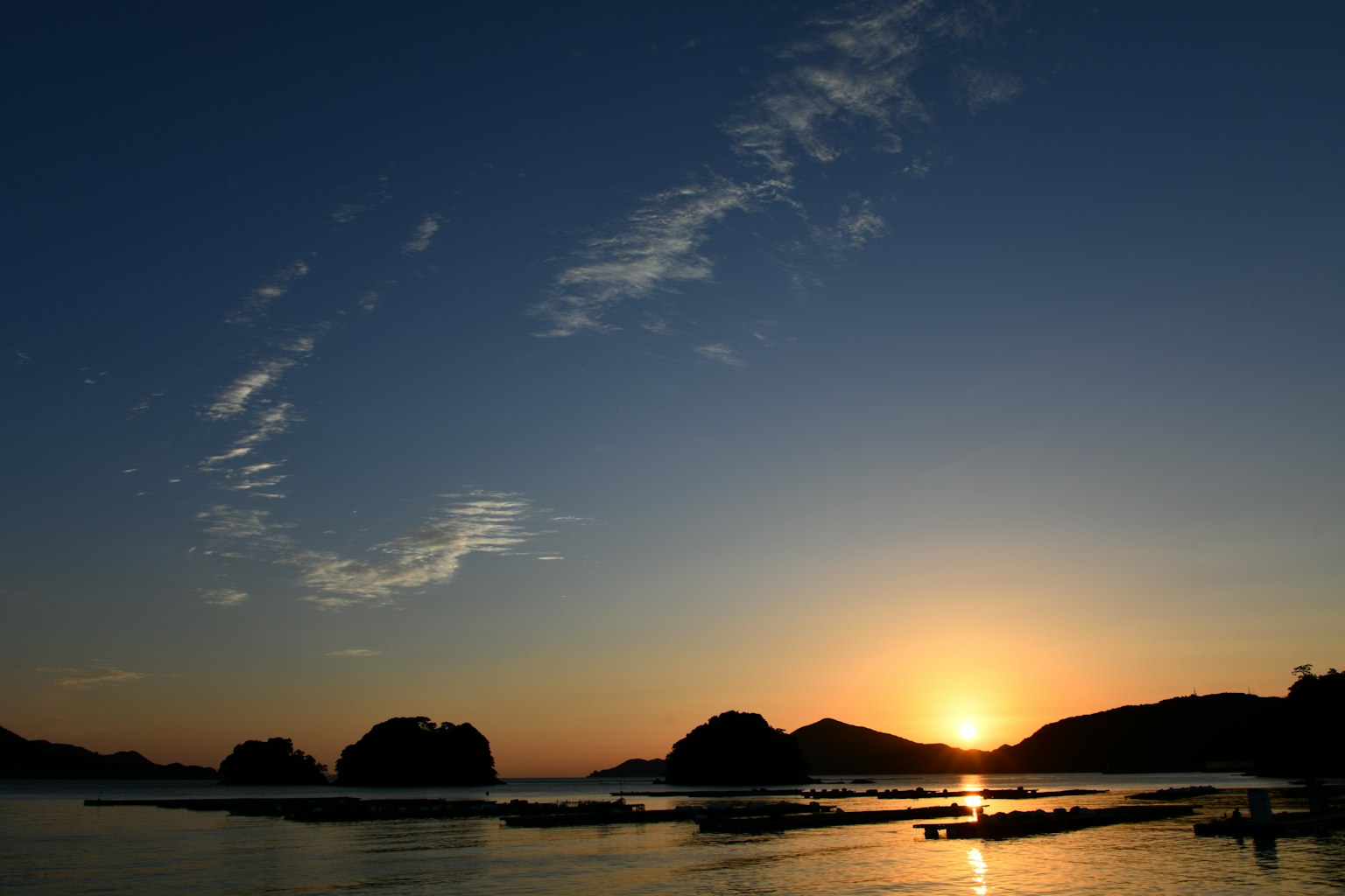 Vue pittoresque de la mer avec des îles silhouettées au coucher du soleil