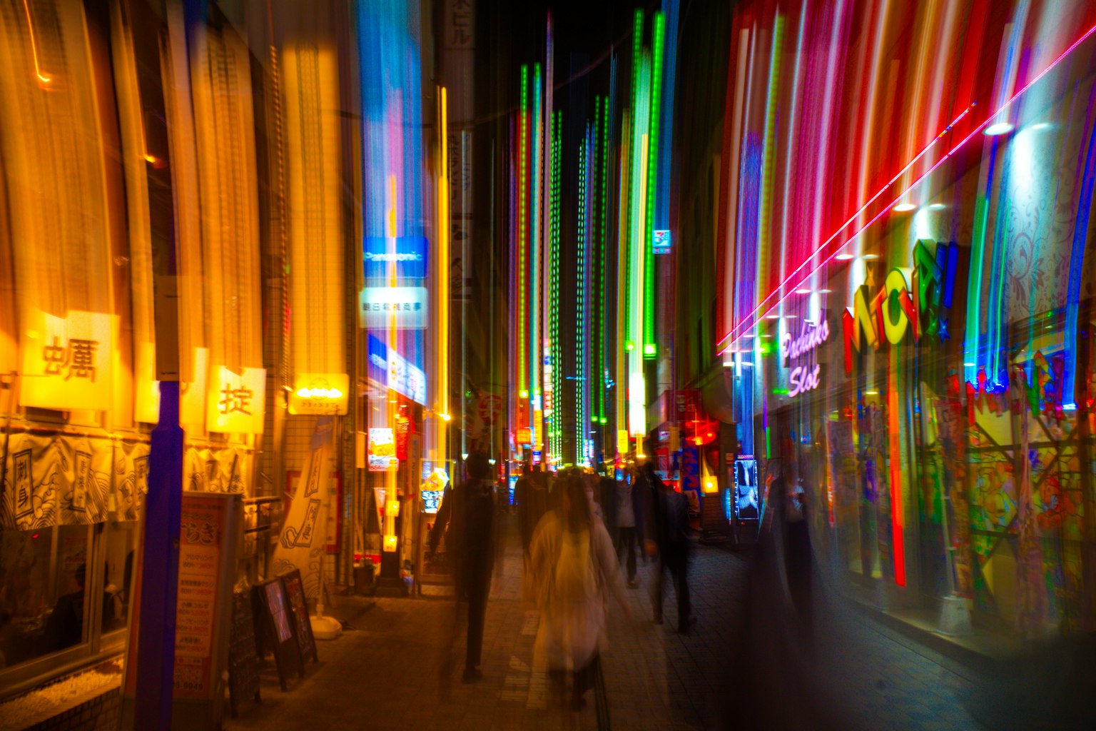 Colorful neon lights streaking down a vibrant city street with pedestrians