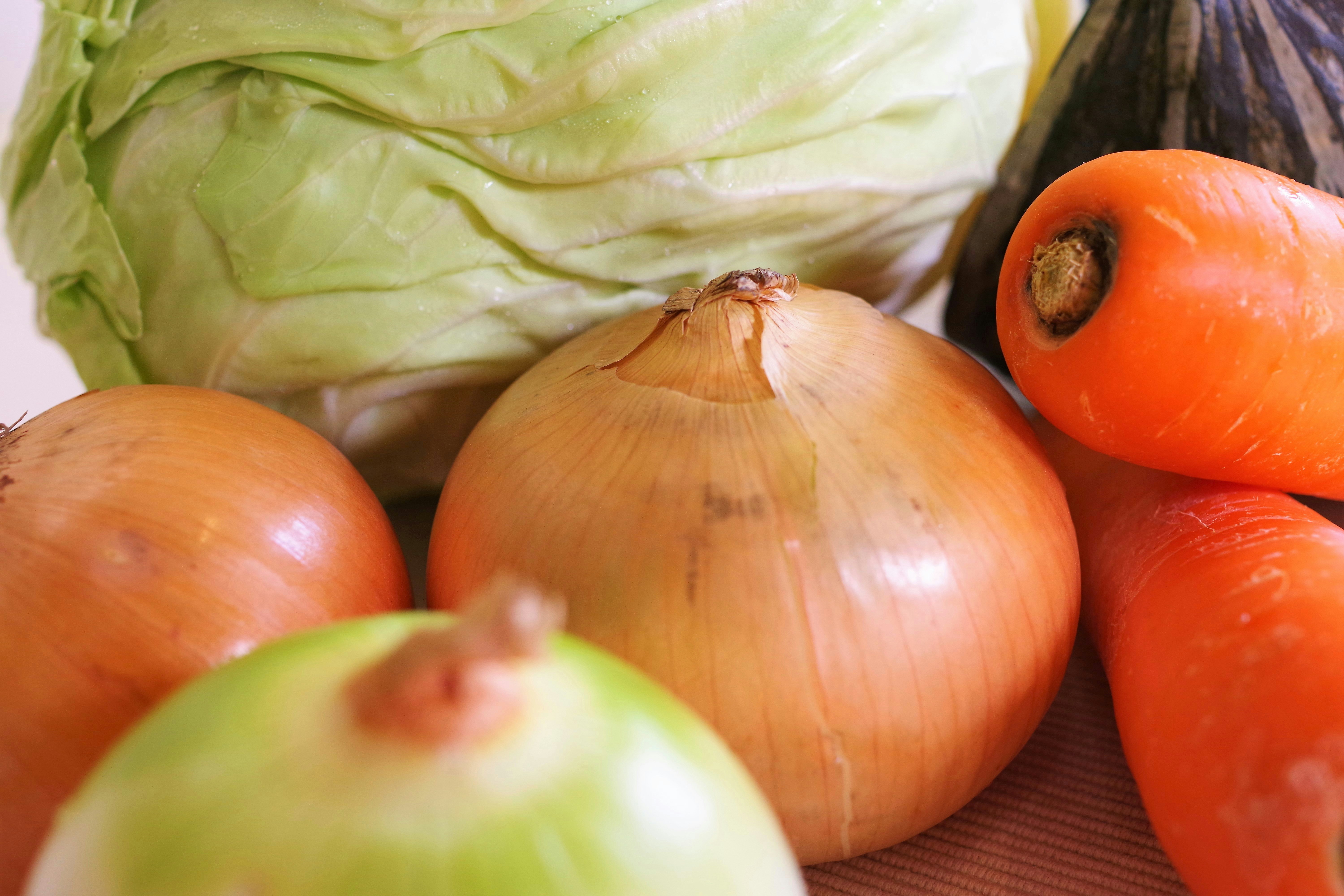 assorted onions, carrots, and cabbage vegetables
