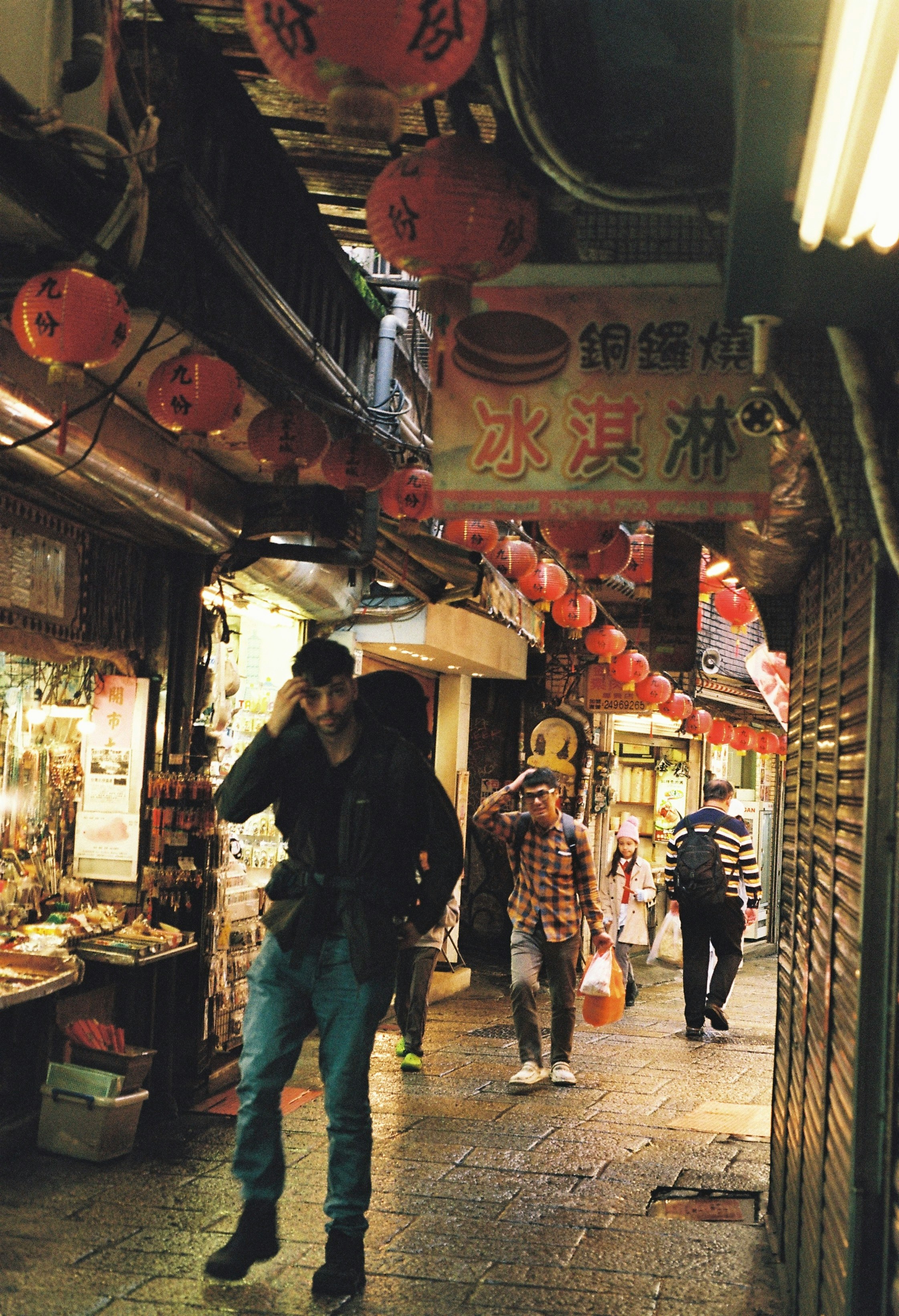 storefront alley with rows of hanging lanterns