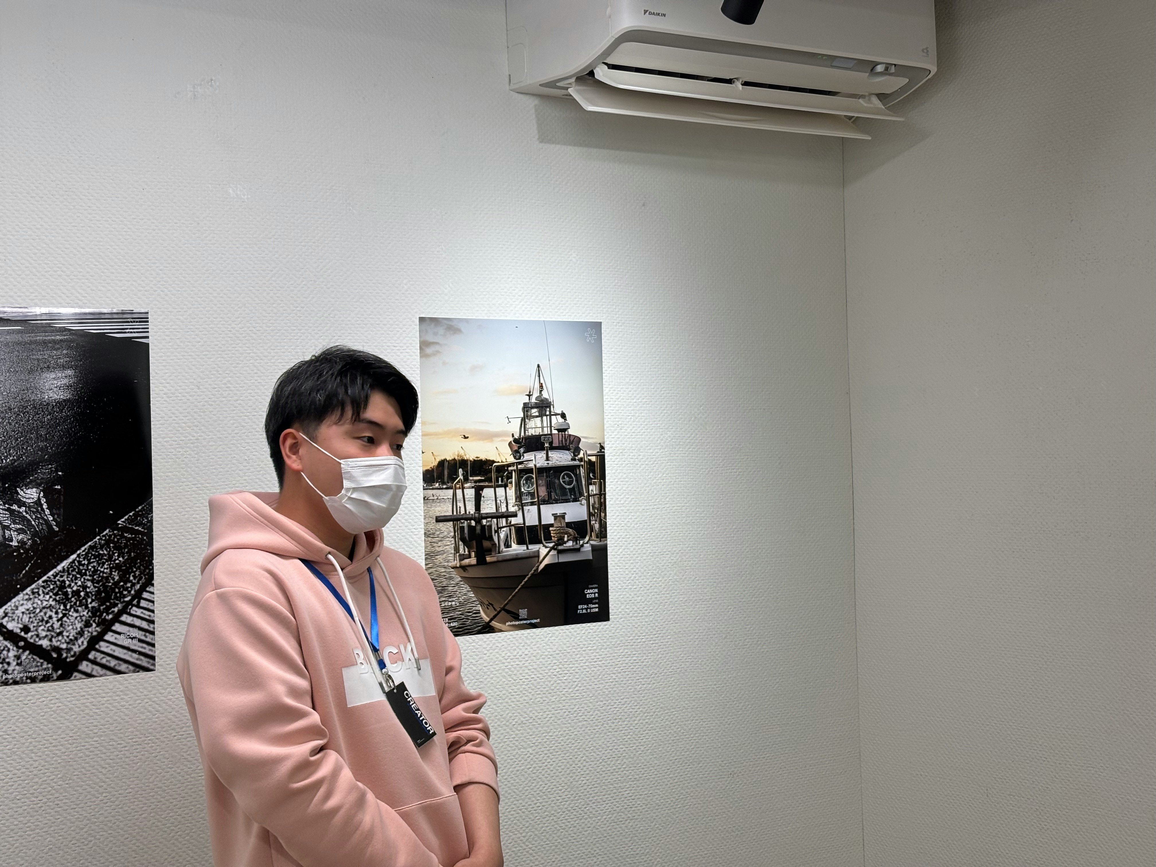 A masked person standing in a Sapporo exhibition room
