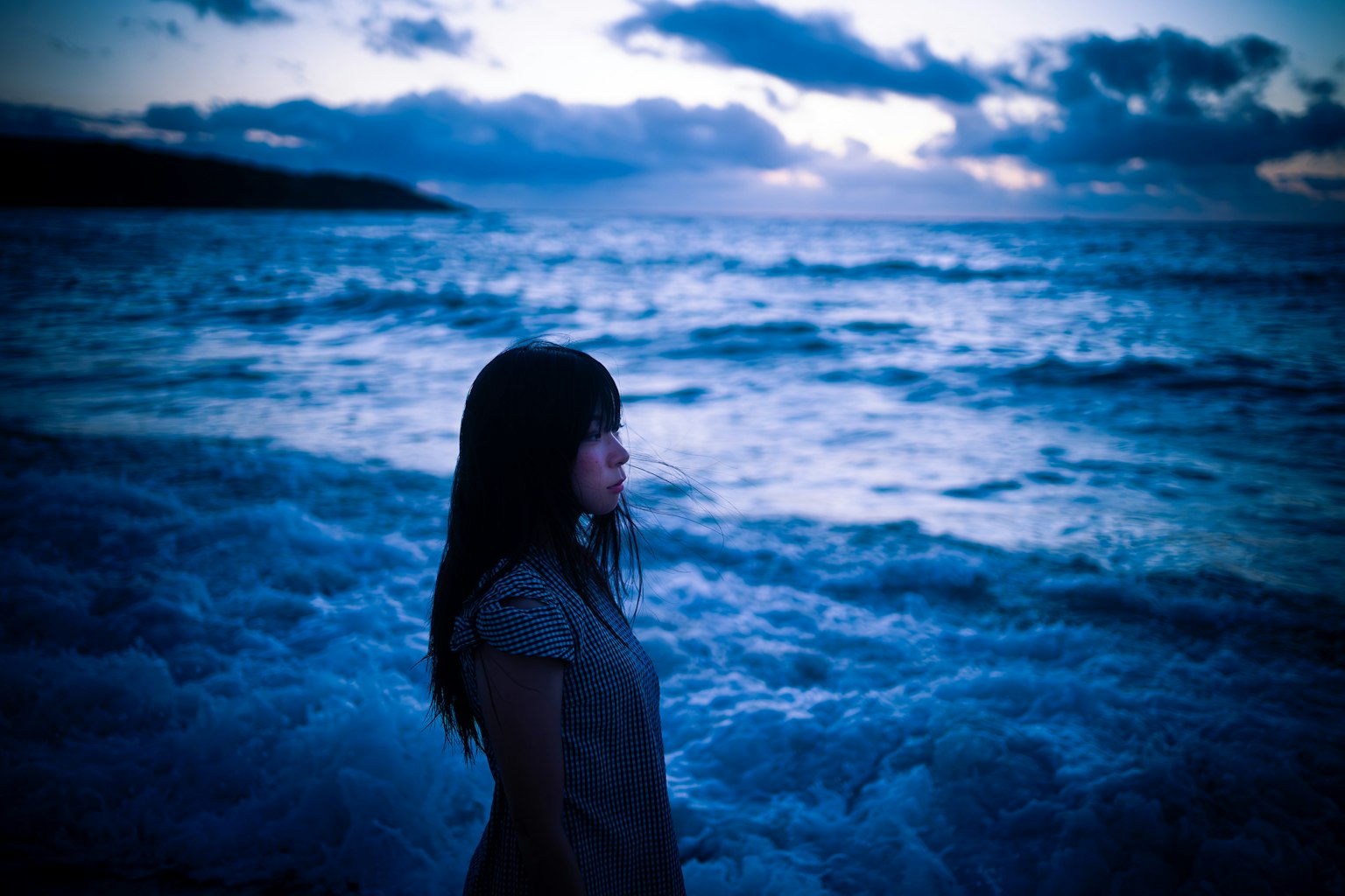 Silueta de una mujer junto a las olas del océano