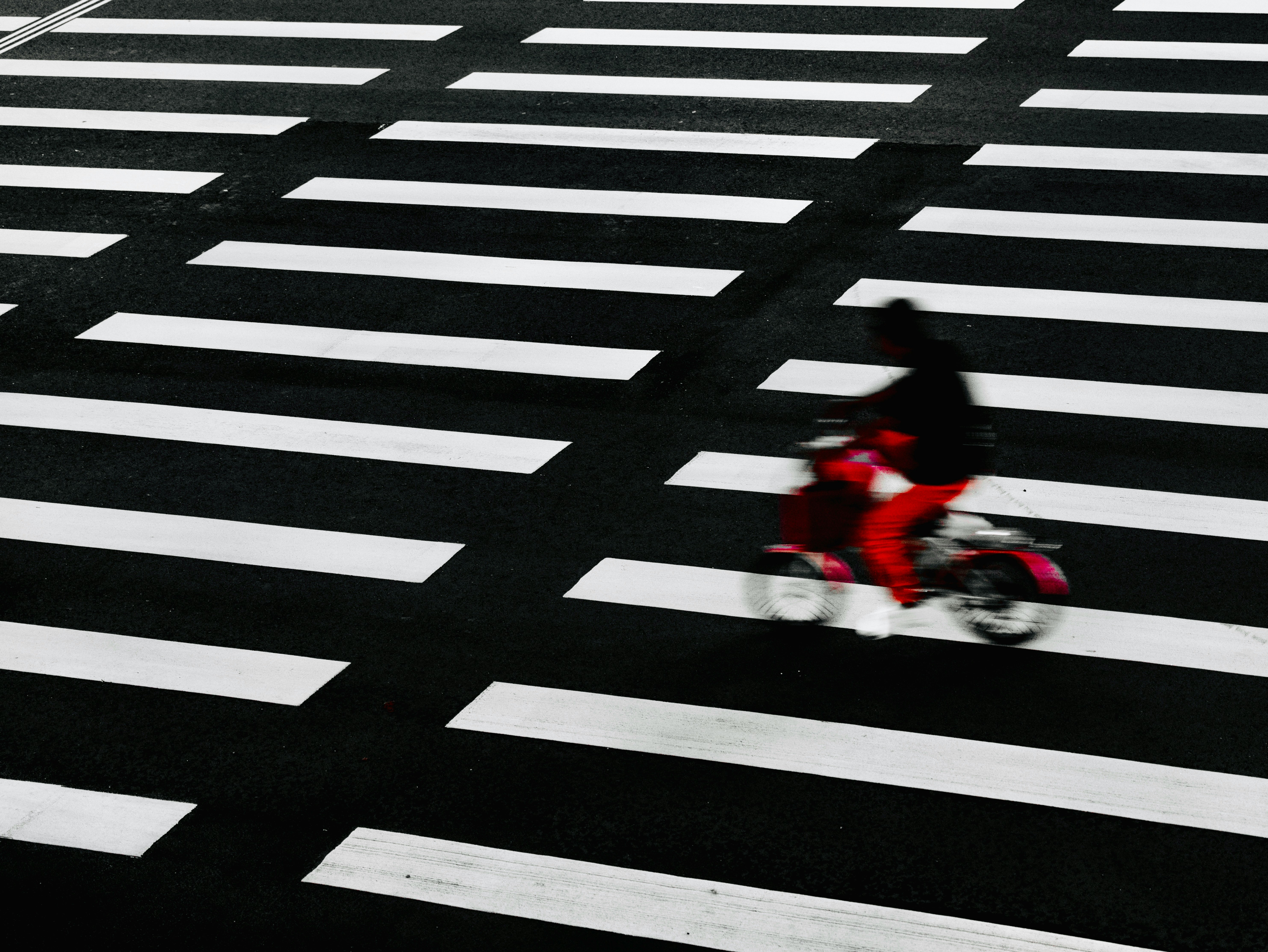 long-exposure street motion of a person crossing at a crosswalk