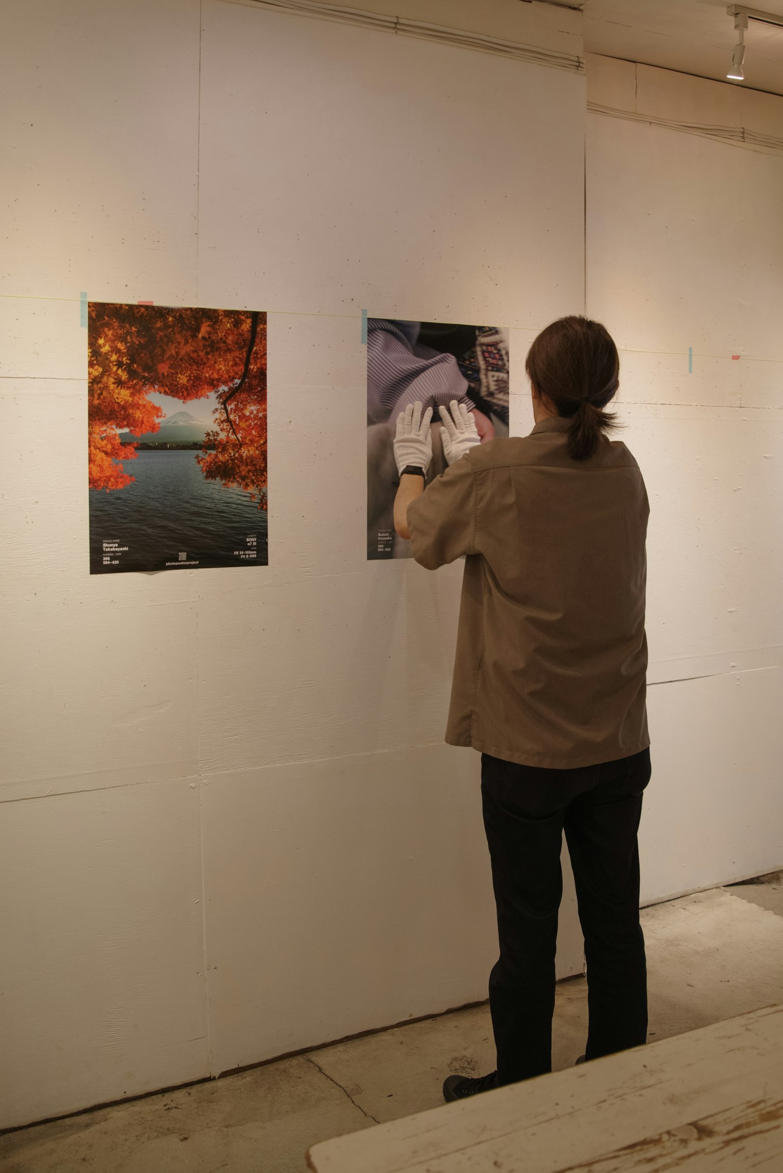 Person observing artwork in an art gallery