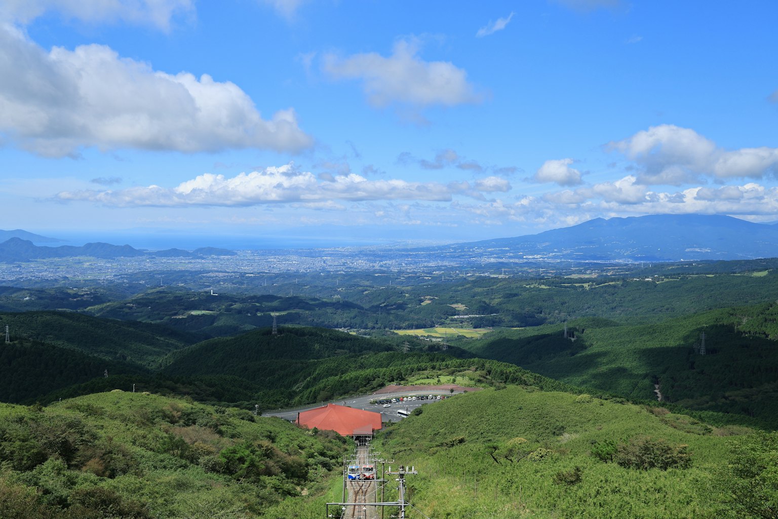 藍天白雲下的綠色山丘美景